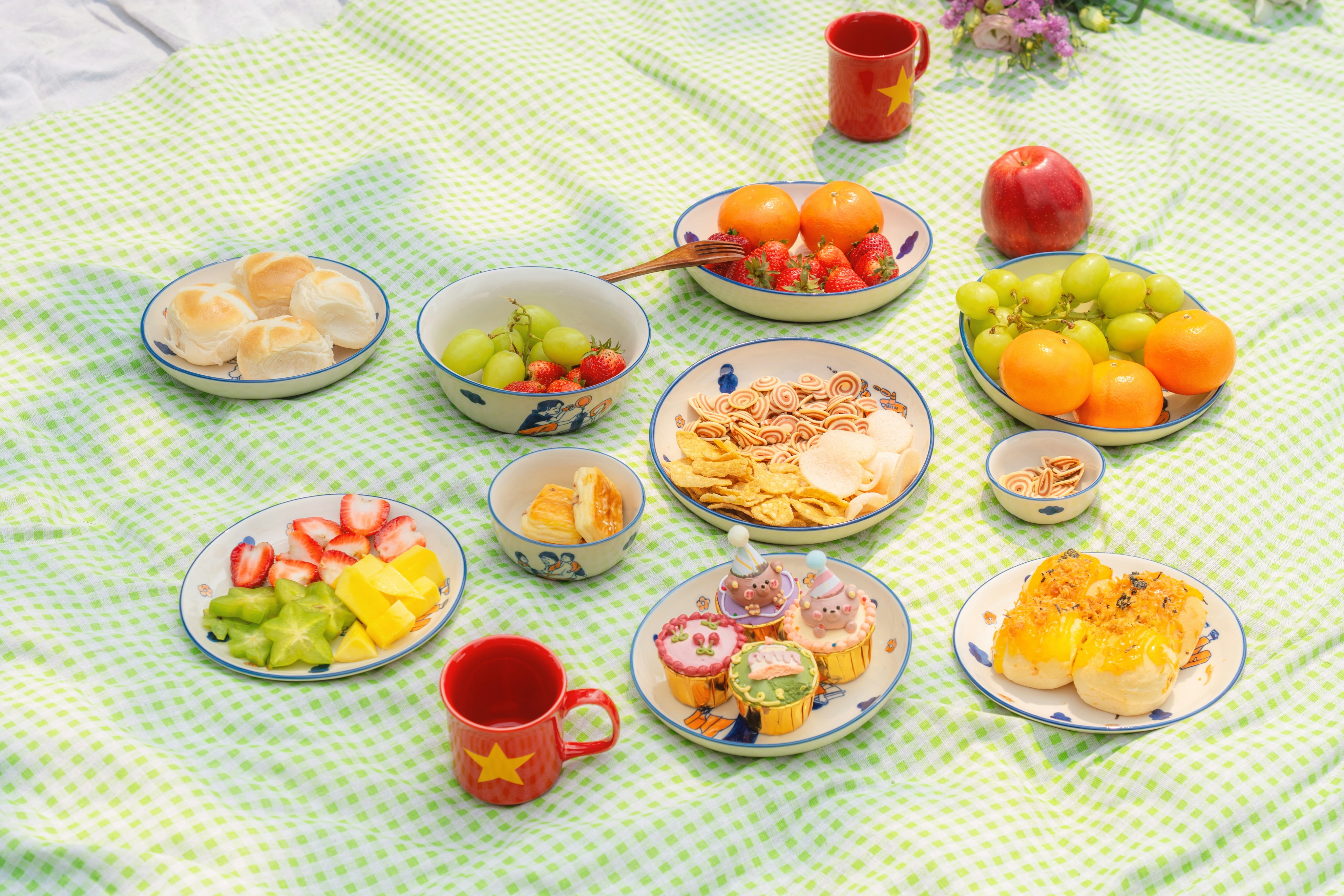 A picnic spread with various fruits and pastries.