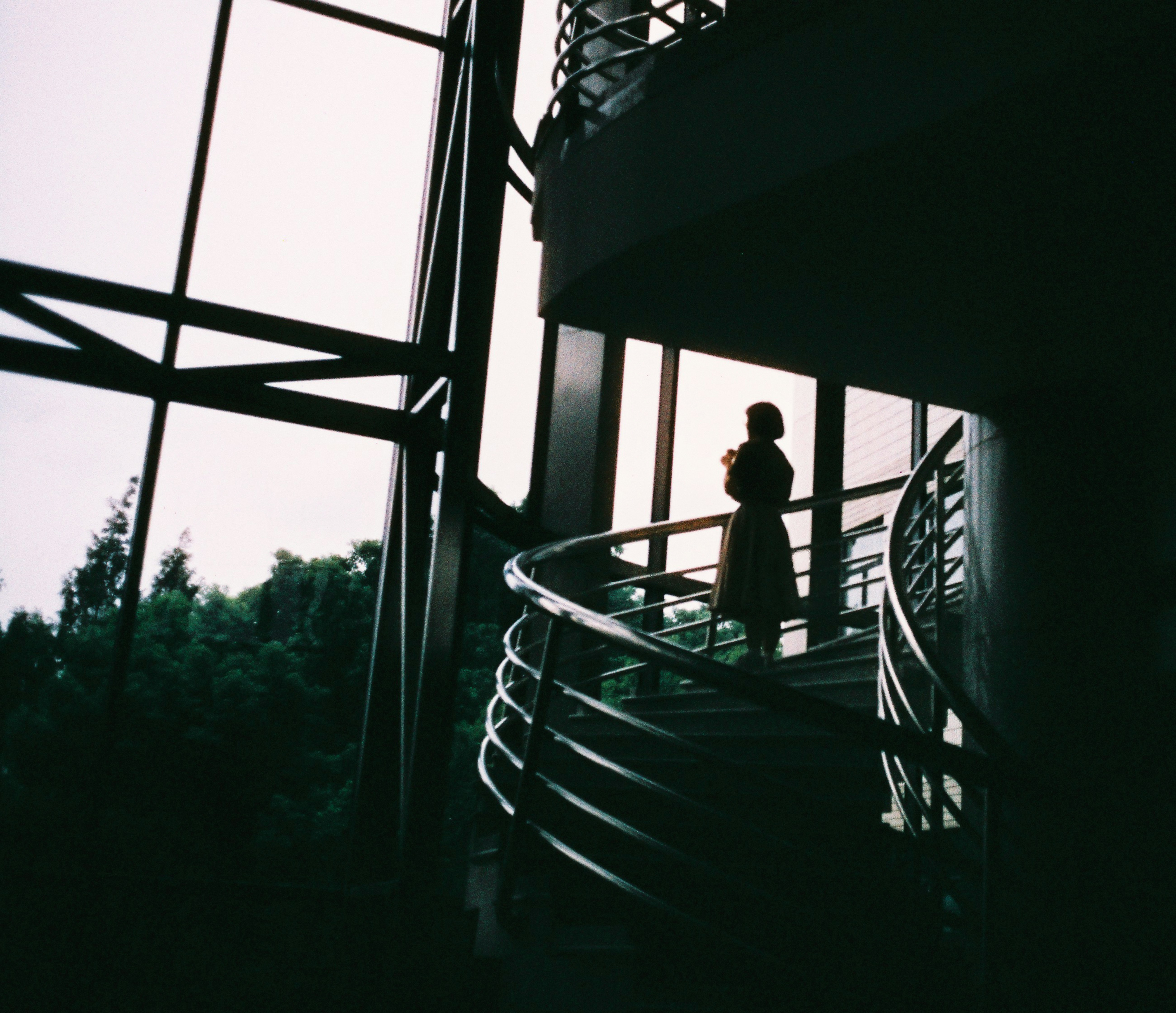 Silhouette of a person on a spiral staircase