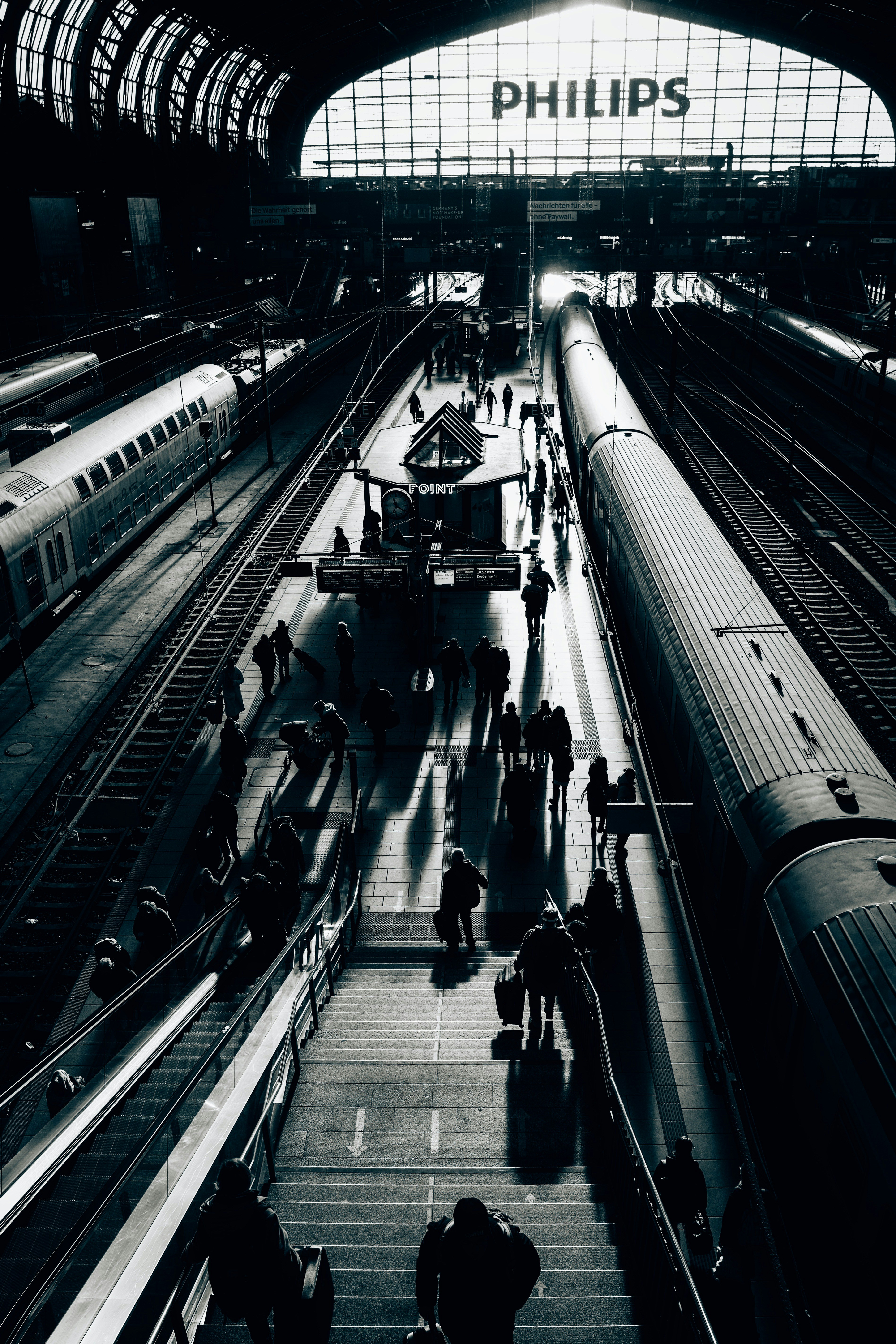 People walking on train station platforms at night