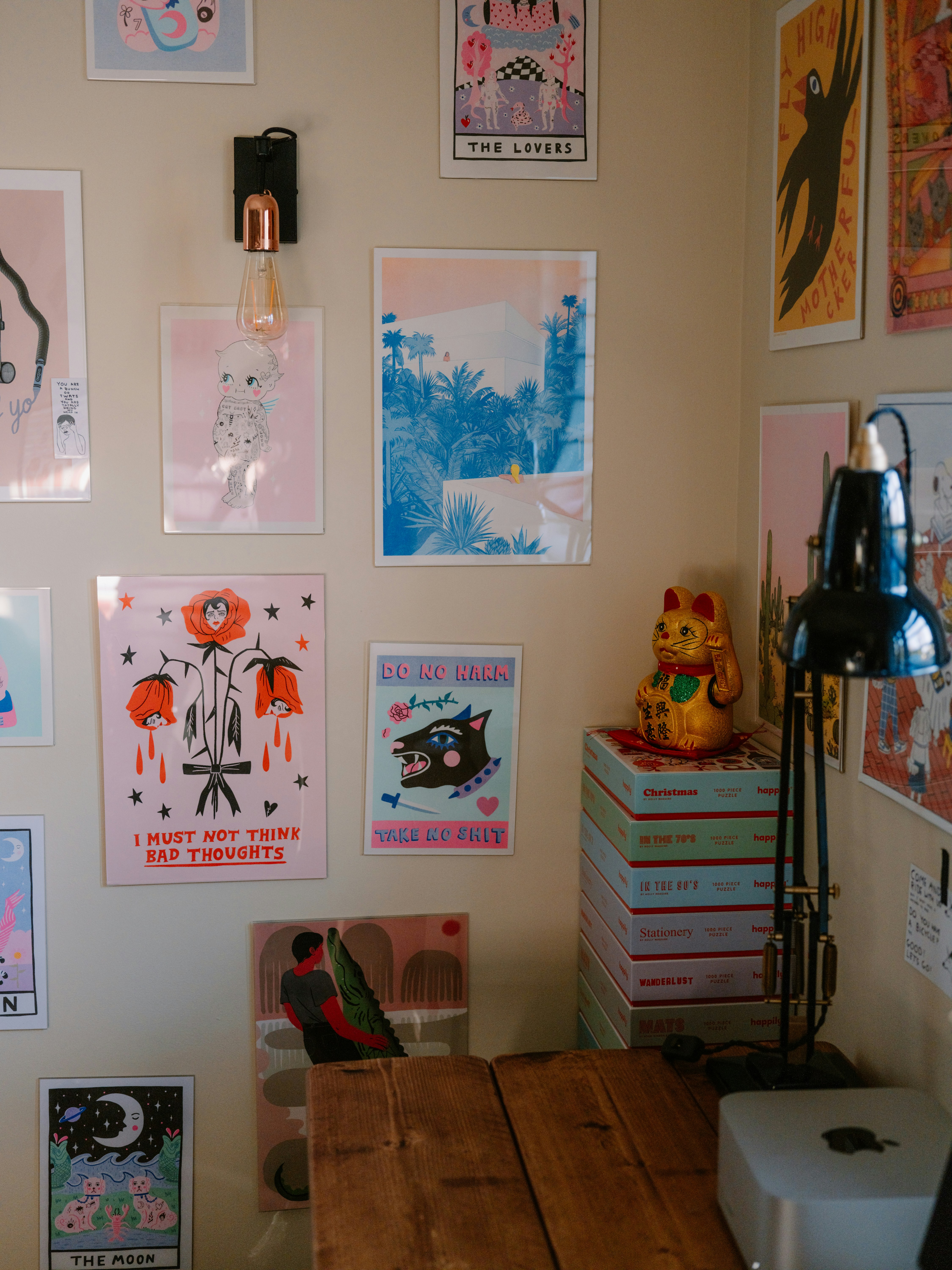 Wall art and a desk with a lamp and lamp.