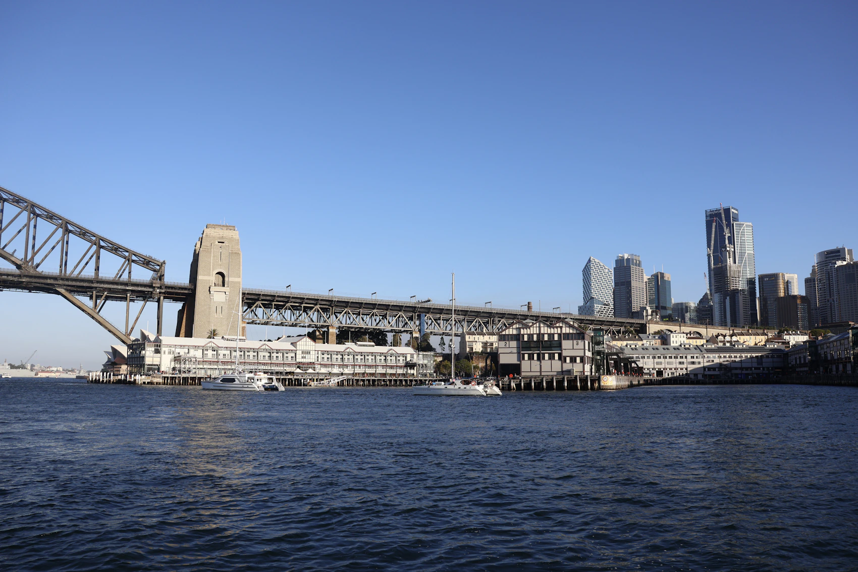 Sydney Harbour Bridge, boats and city skyline viewed from The Rocks
