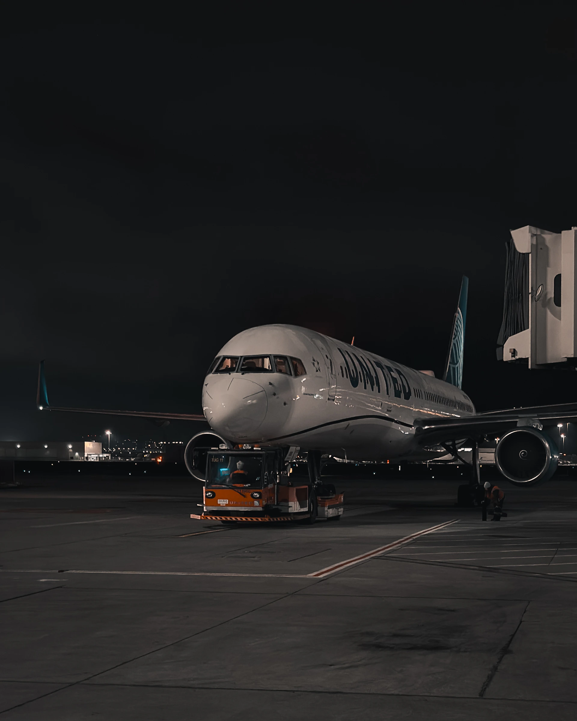 Airplane at airport gate at night