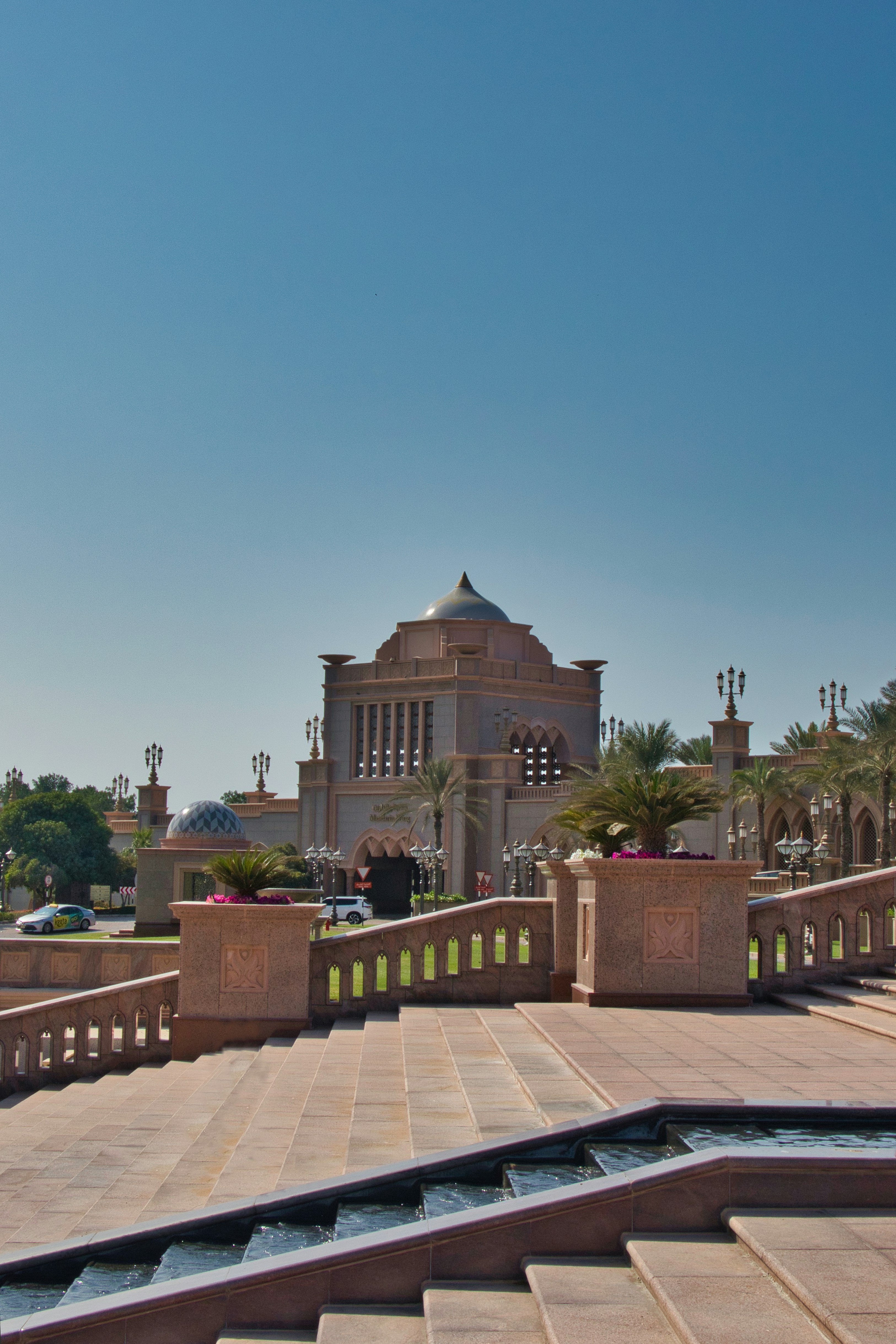 Grand building with ornate architecture and palm trees.