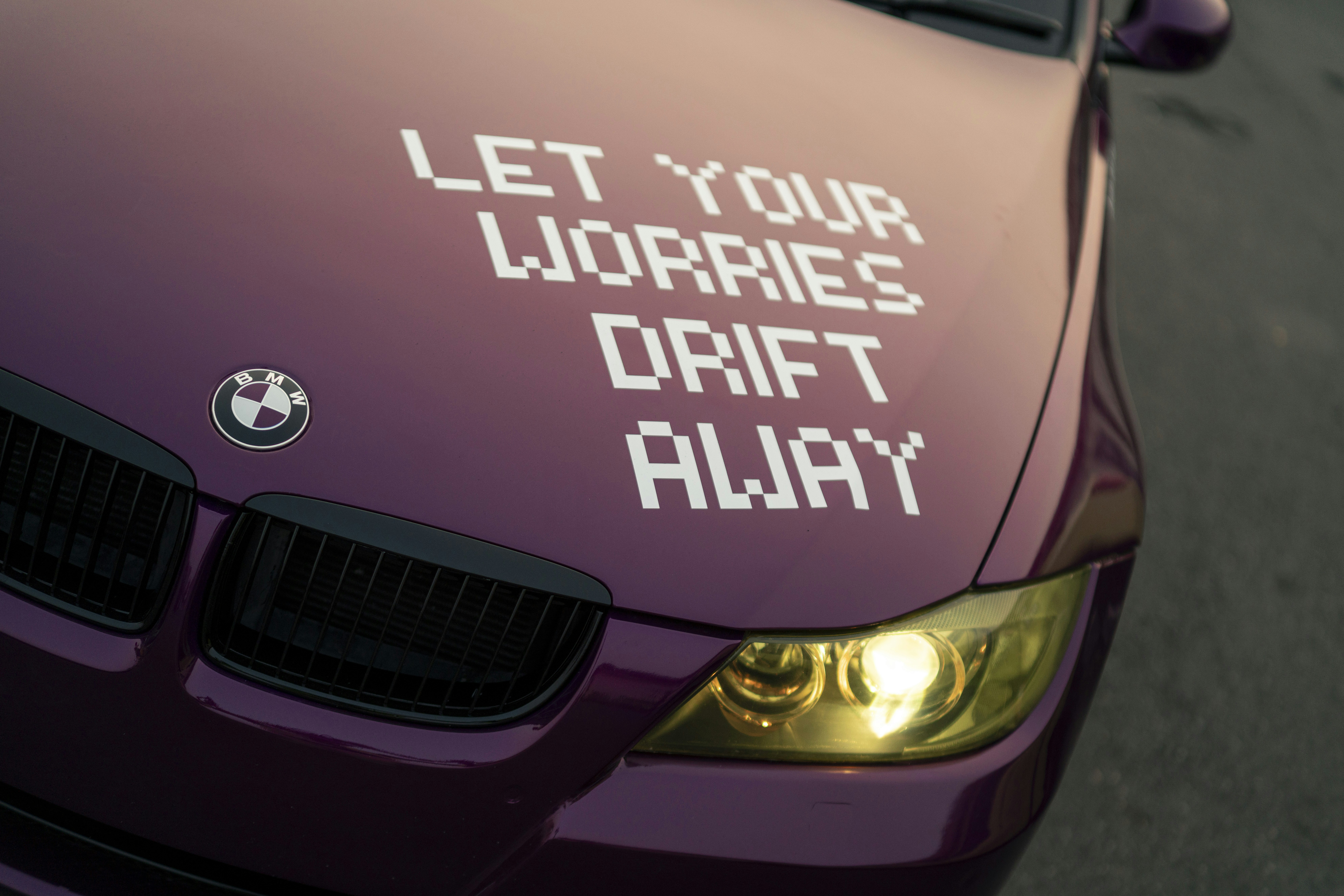 Purple car hood with text "let your worries drift away"