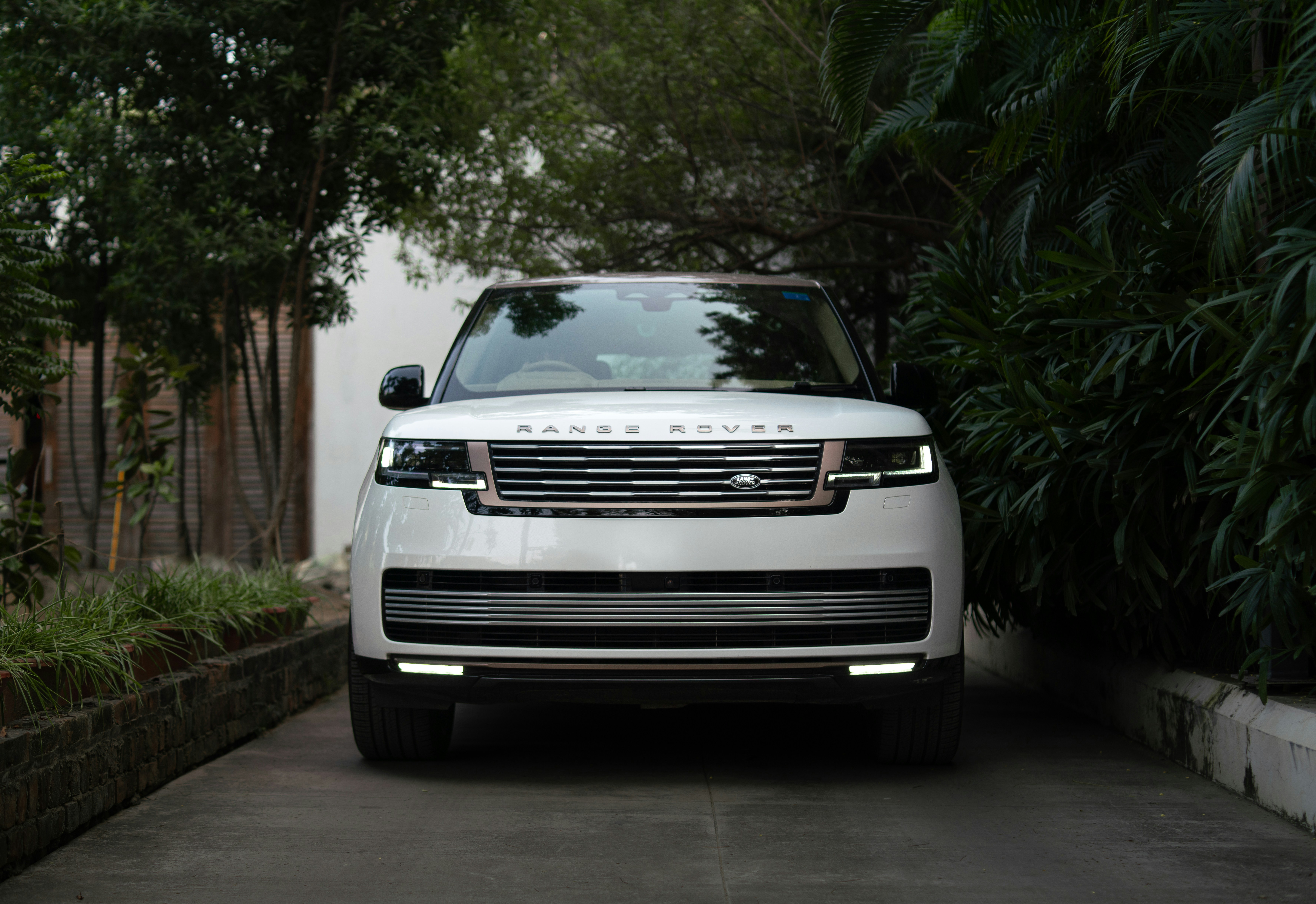 White range rover parked on a paved driveway.
