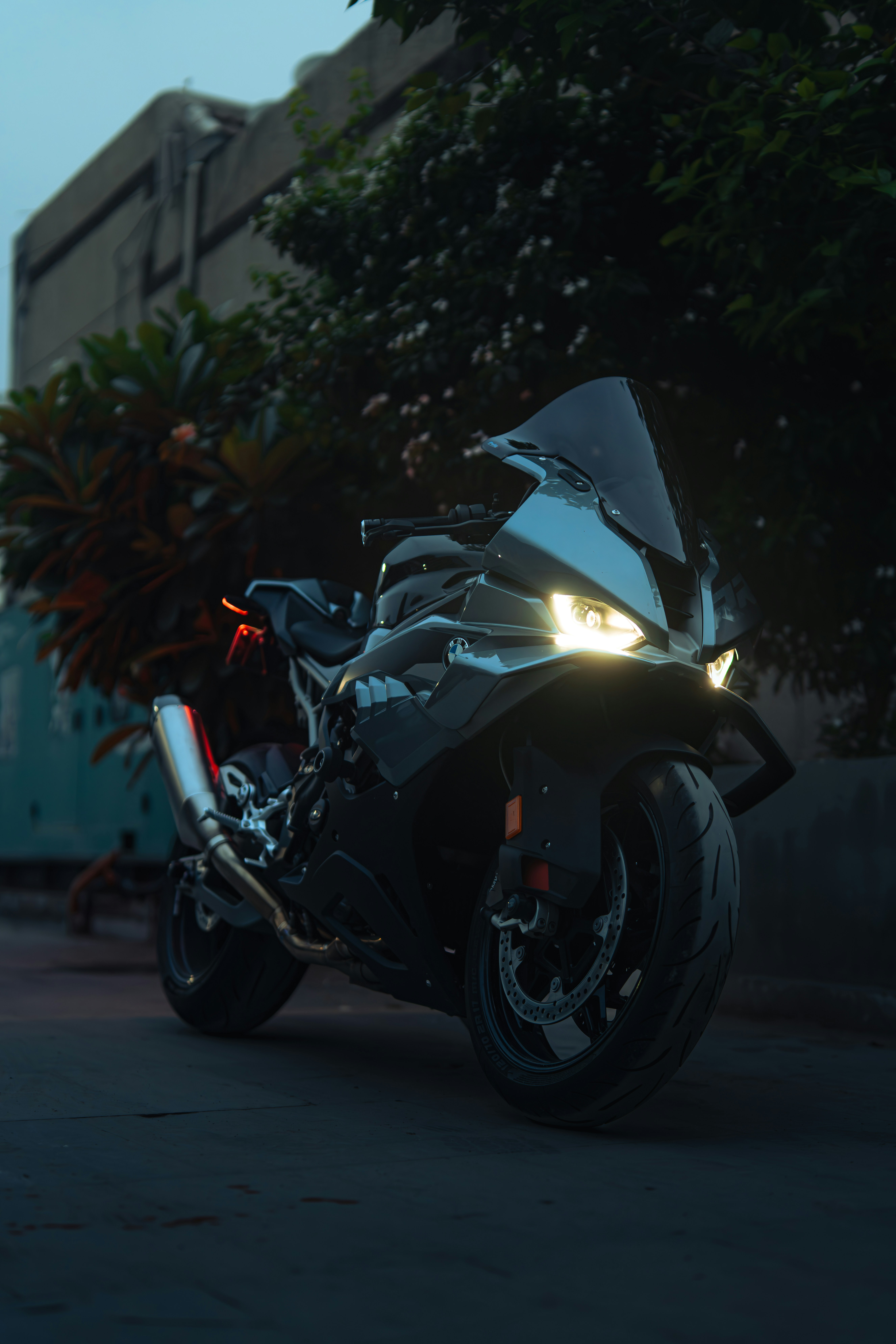 A sleek black motorcycle parked at dusk.