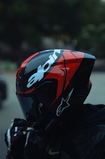 Motorcyclist wearing a red and black helmet