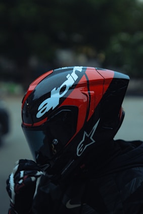 Motorcyclist wearing a red and black helmet