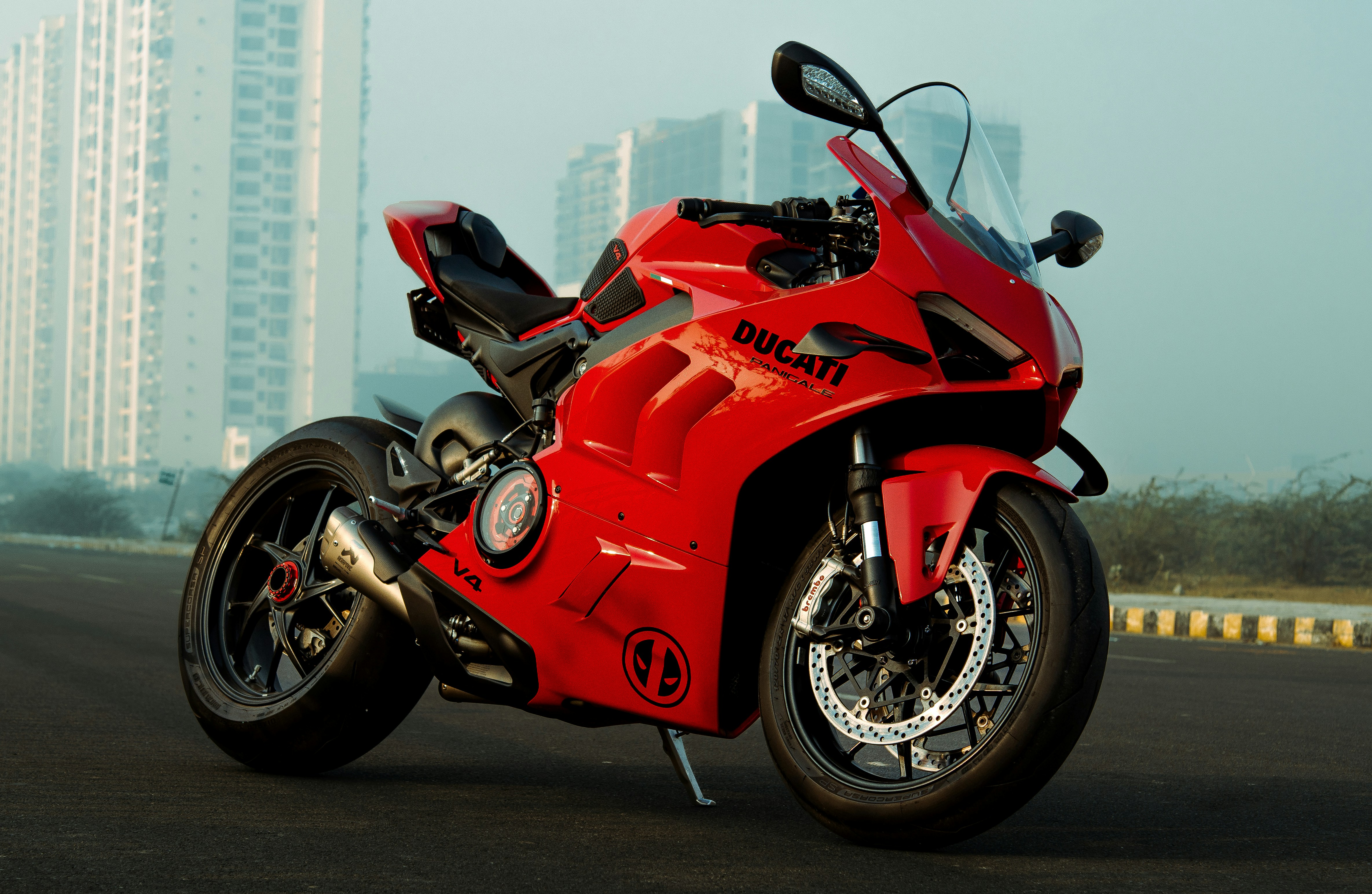 A bright red sport motorcycle parked on a road.
