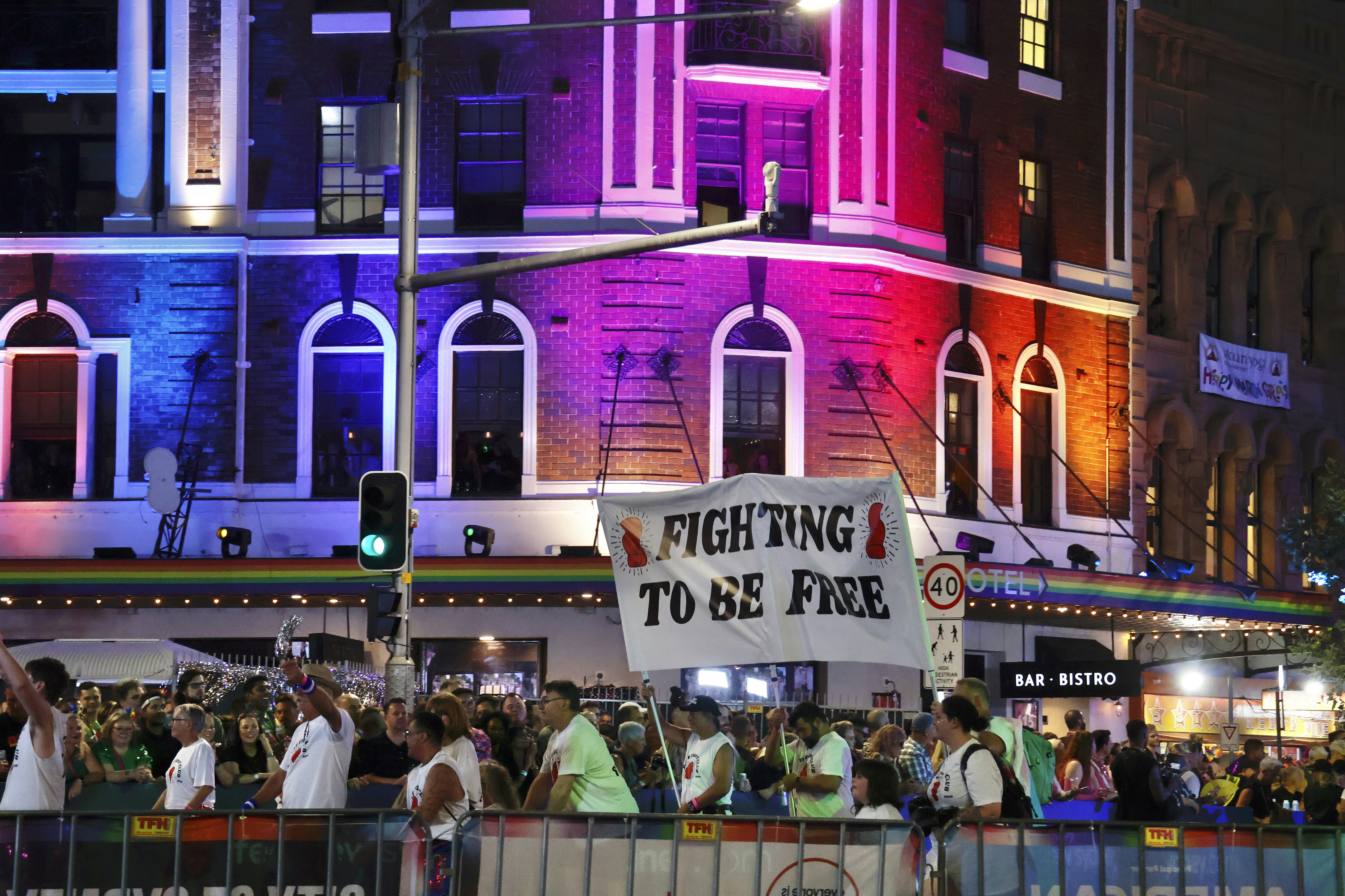 Crowd with banner at illuminated building