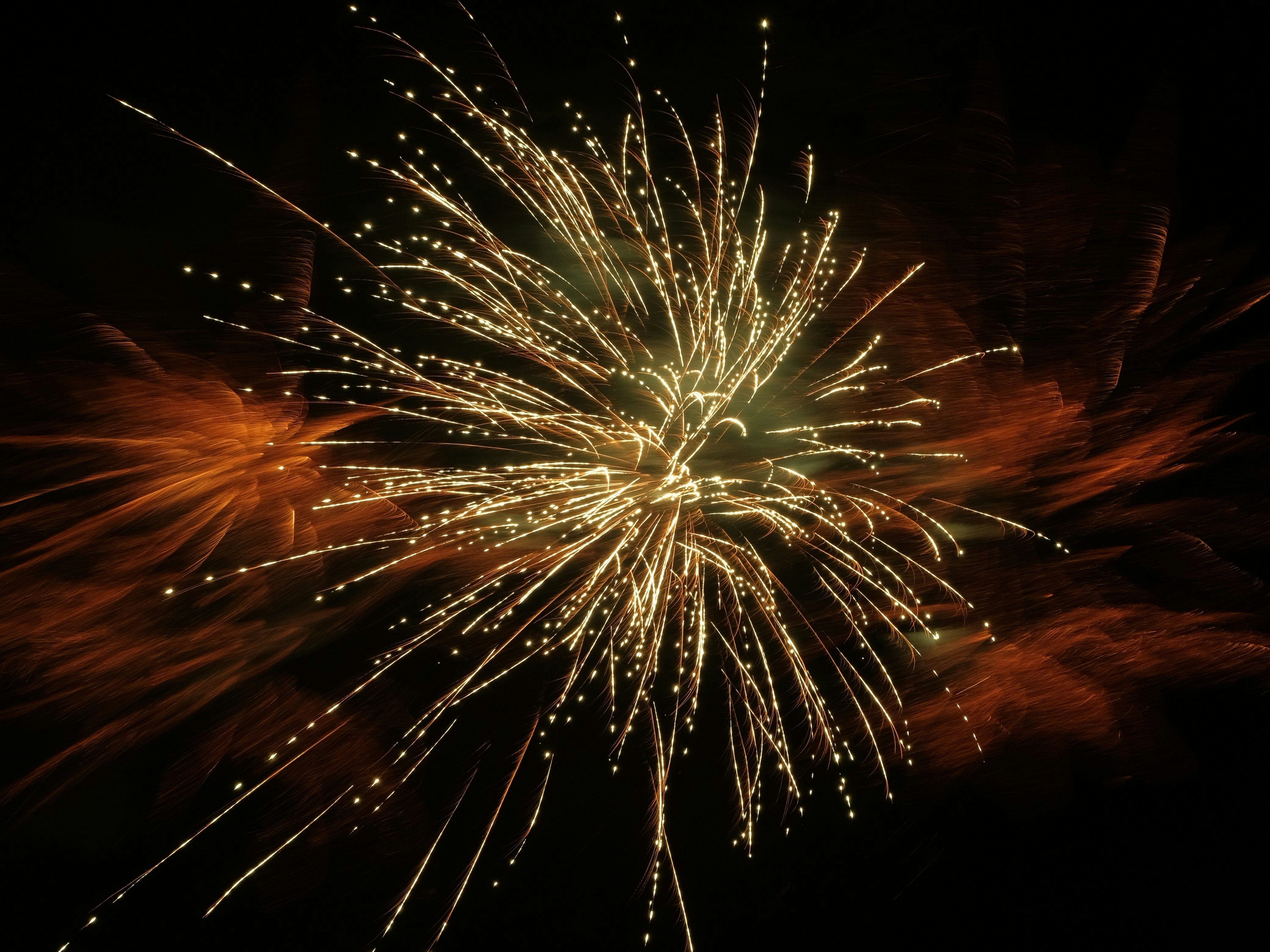 Bright fireworks exploding in the dark night sky.