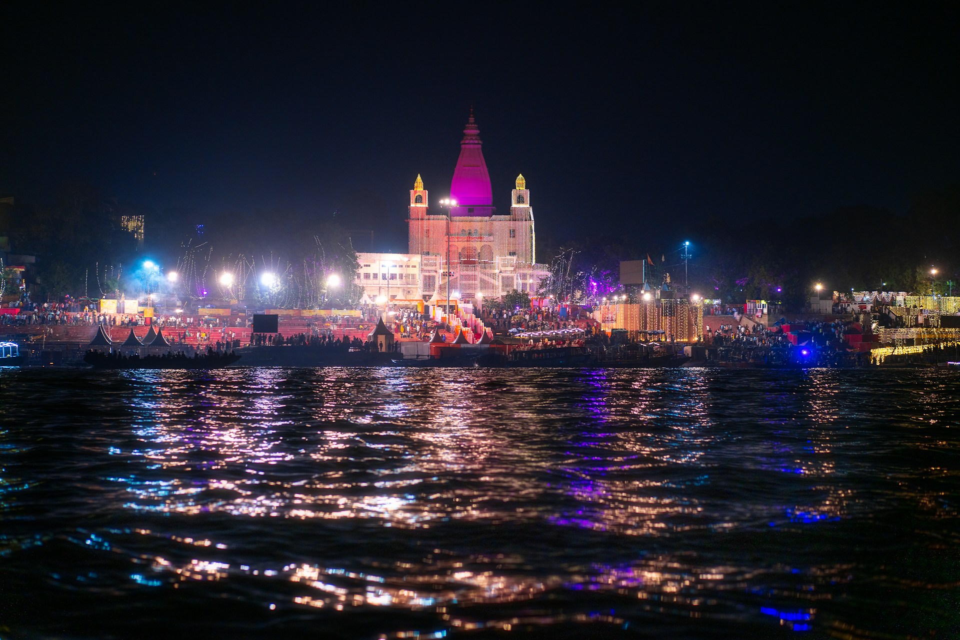 Temple illuminated at night with reflections on water