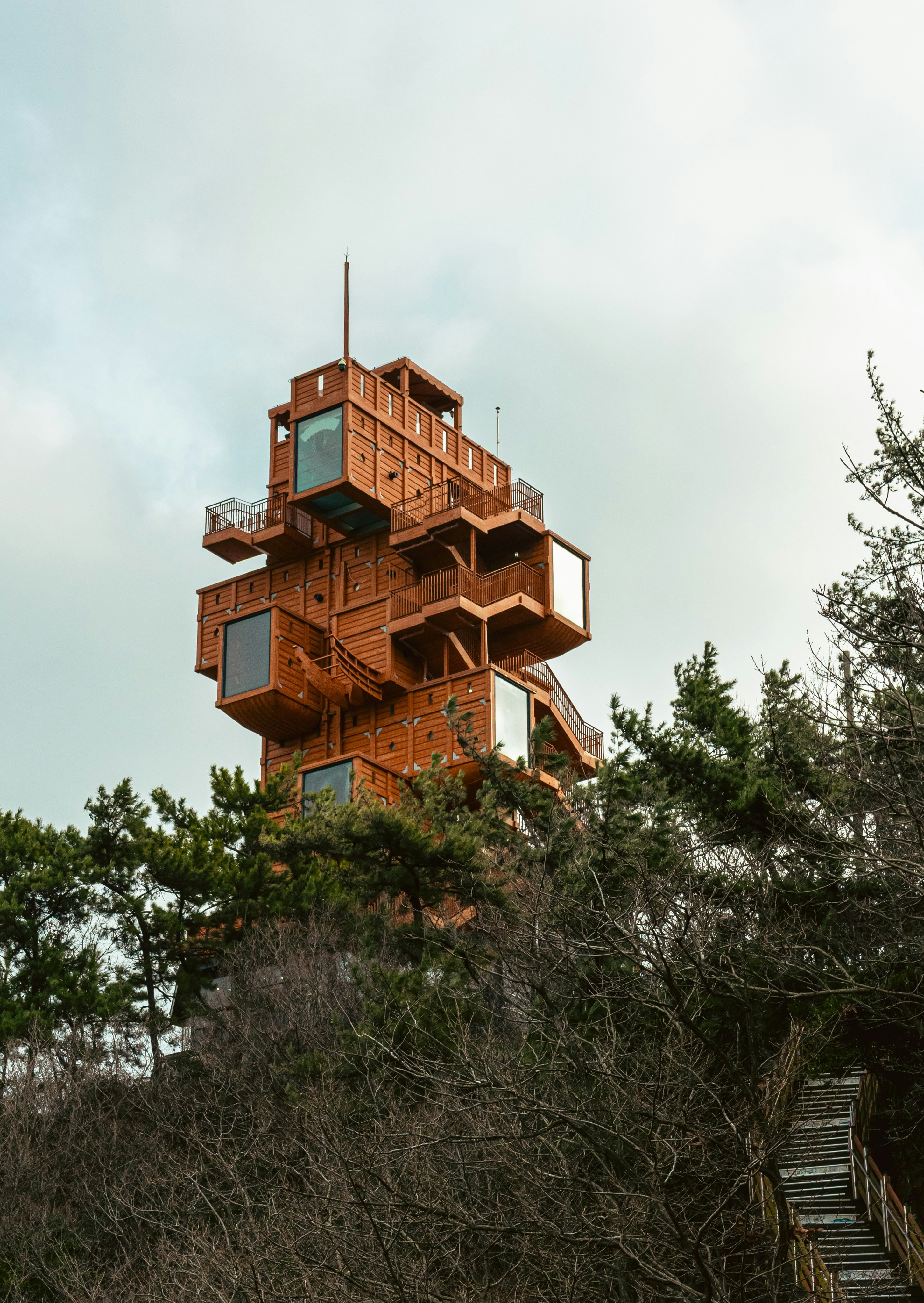 Unusual wooden tower building among trees