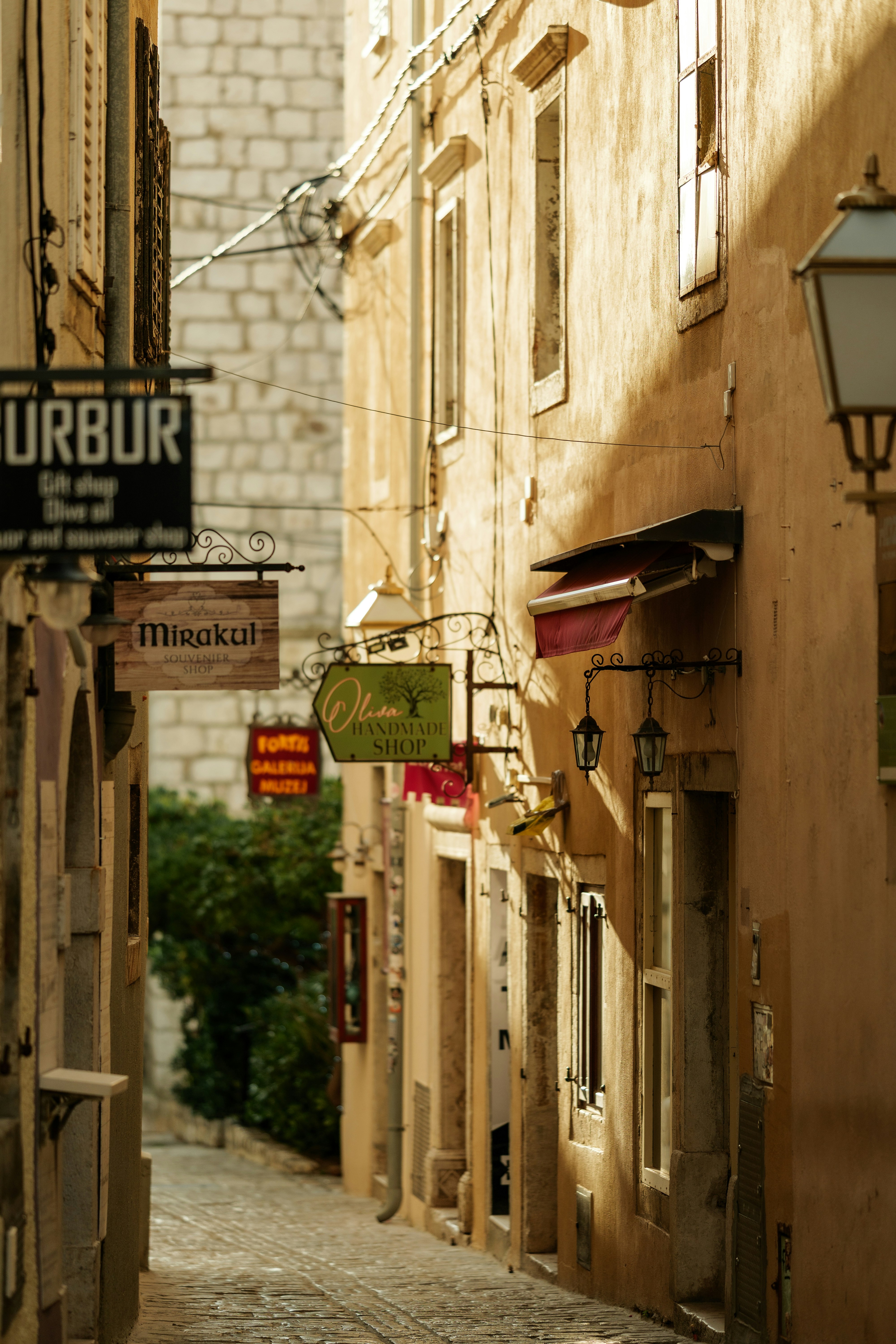 Narrow european street with old buildings and signs.