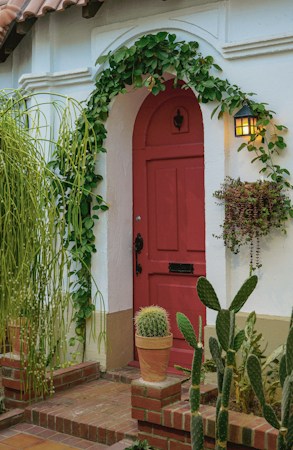 Front entry of a Southern Nevada home with cactus and low-water plants beside the door