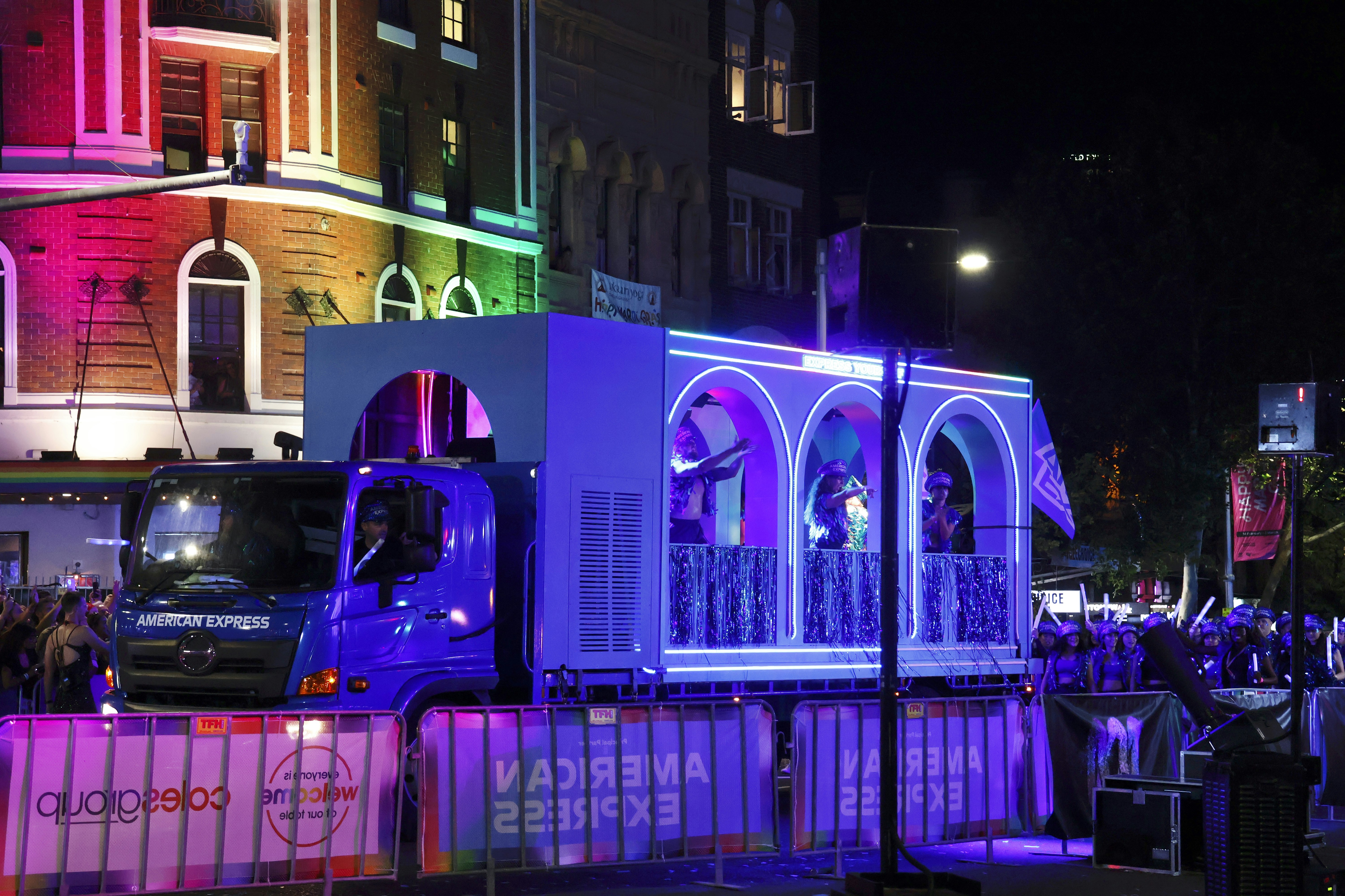 A brightly lit parade float at night