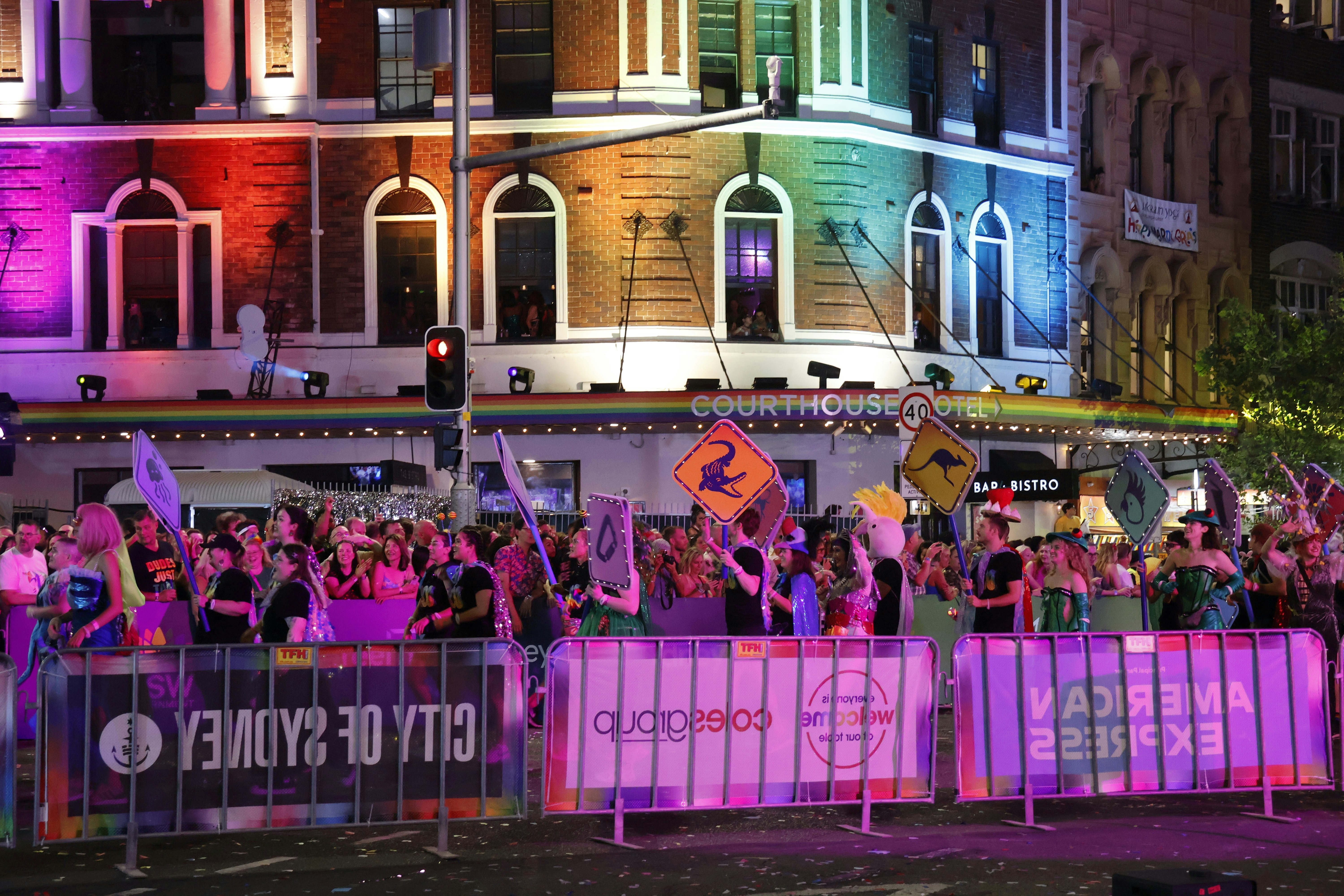 Crowd celebrating at a vibrant city festival at night