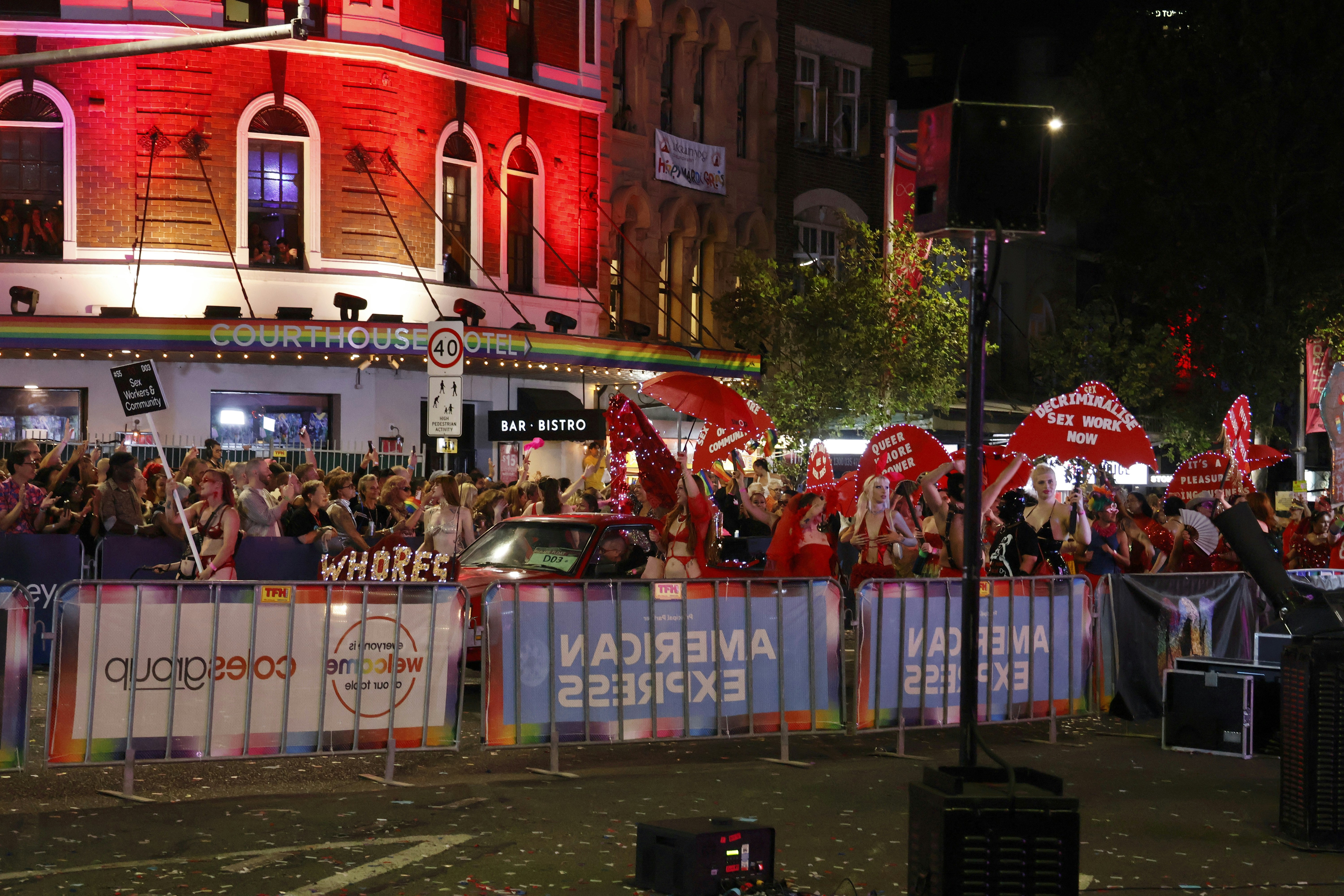 Photo of a sex work decrimalization rally at night.