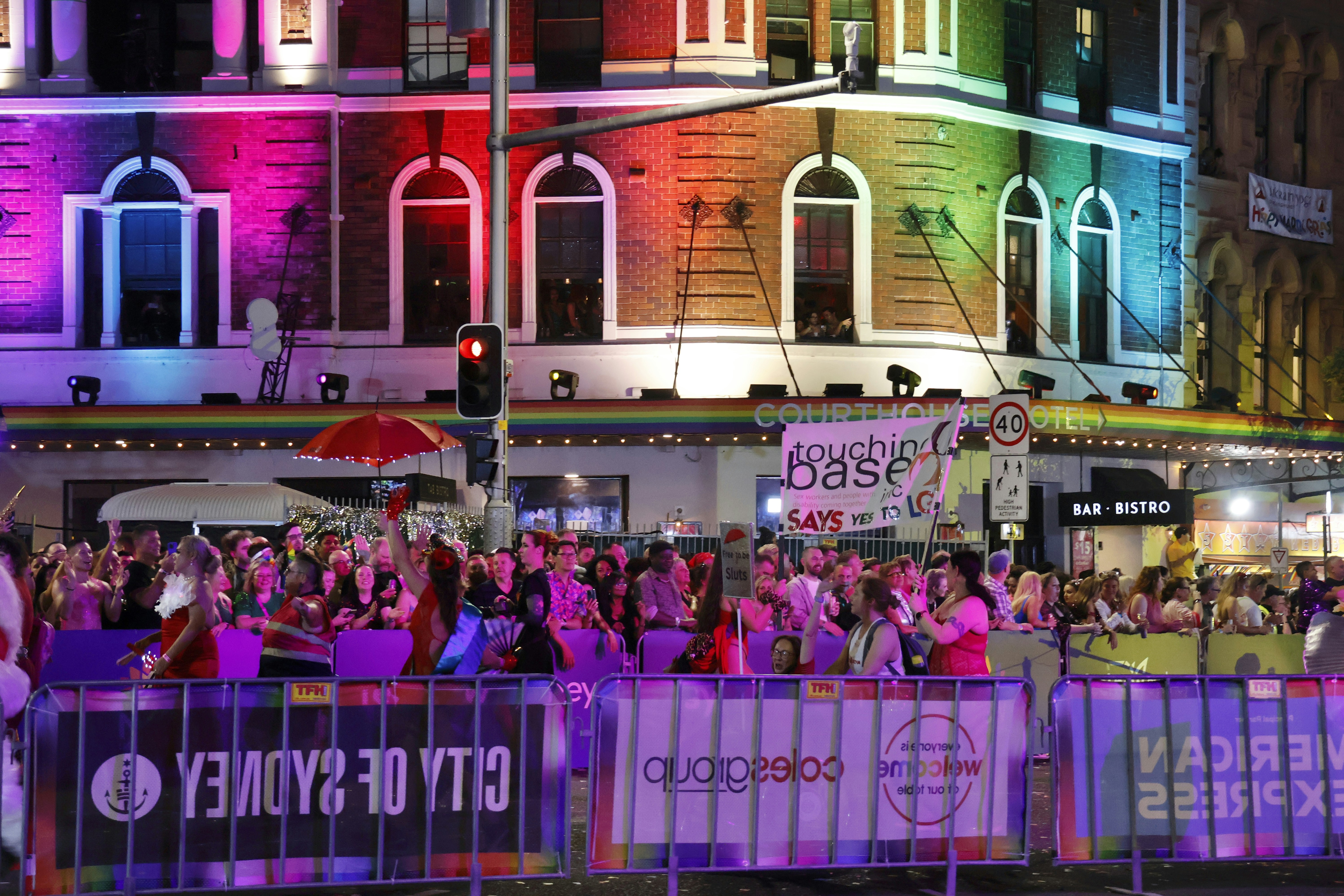 Crowd celebrating at a colorful illuminated city event