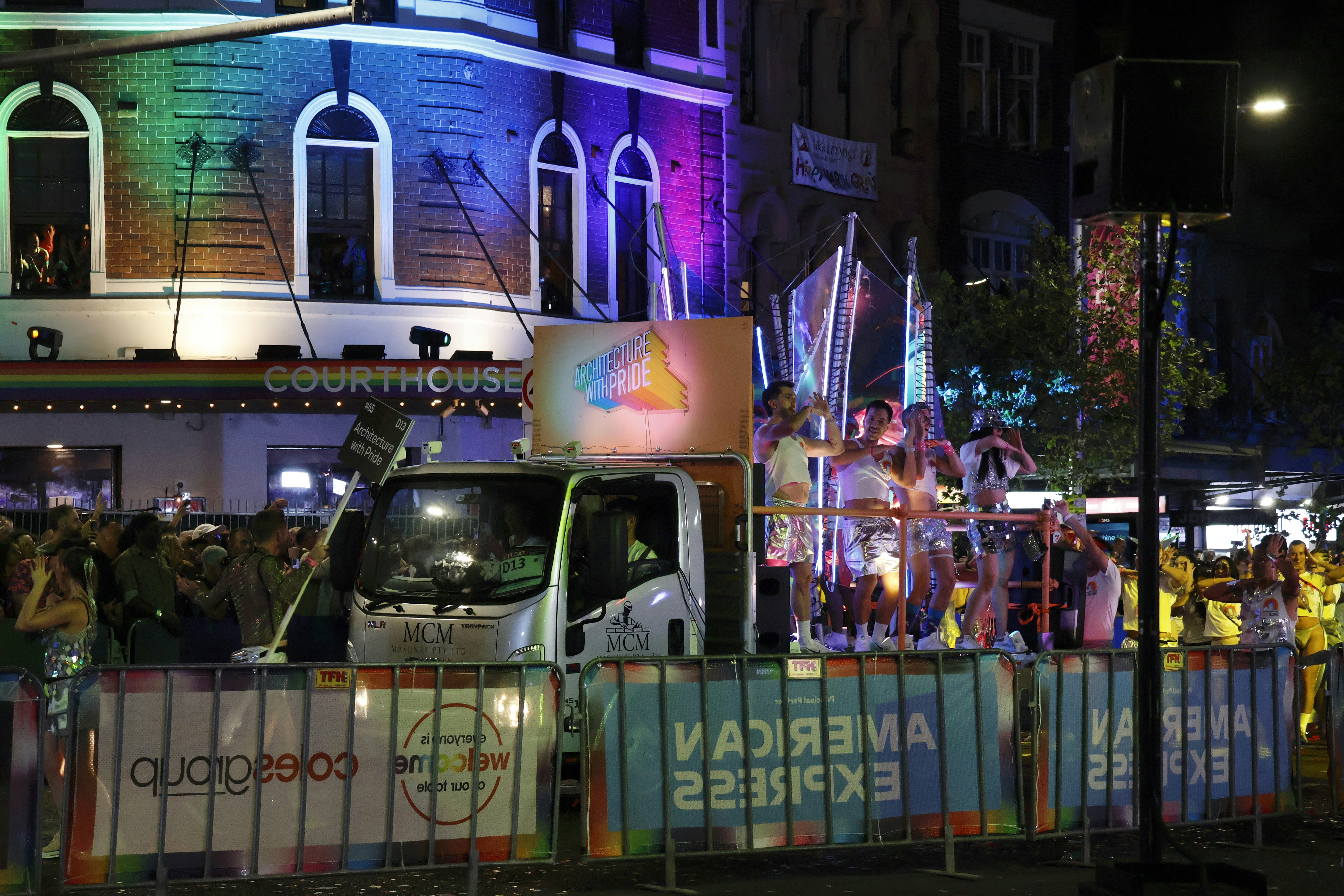 People celebrate on a float at night