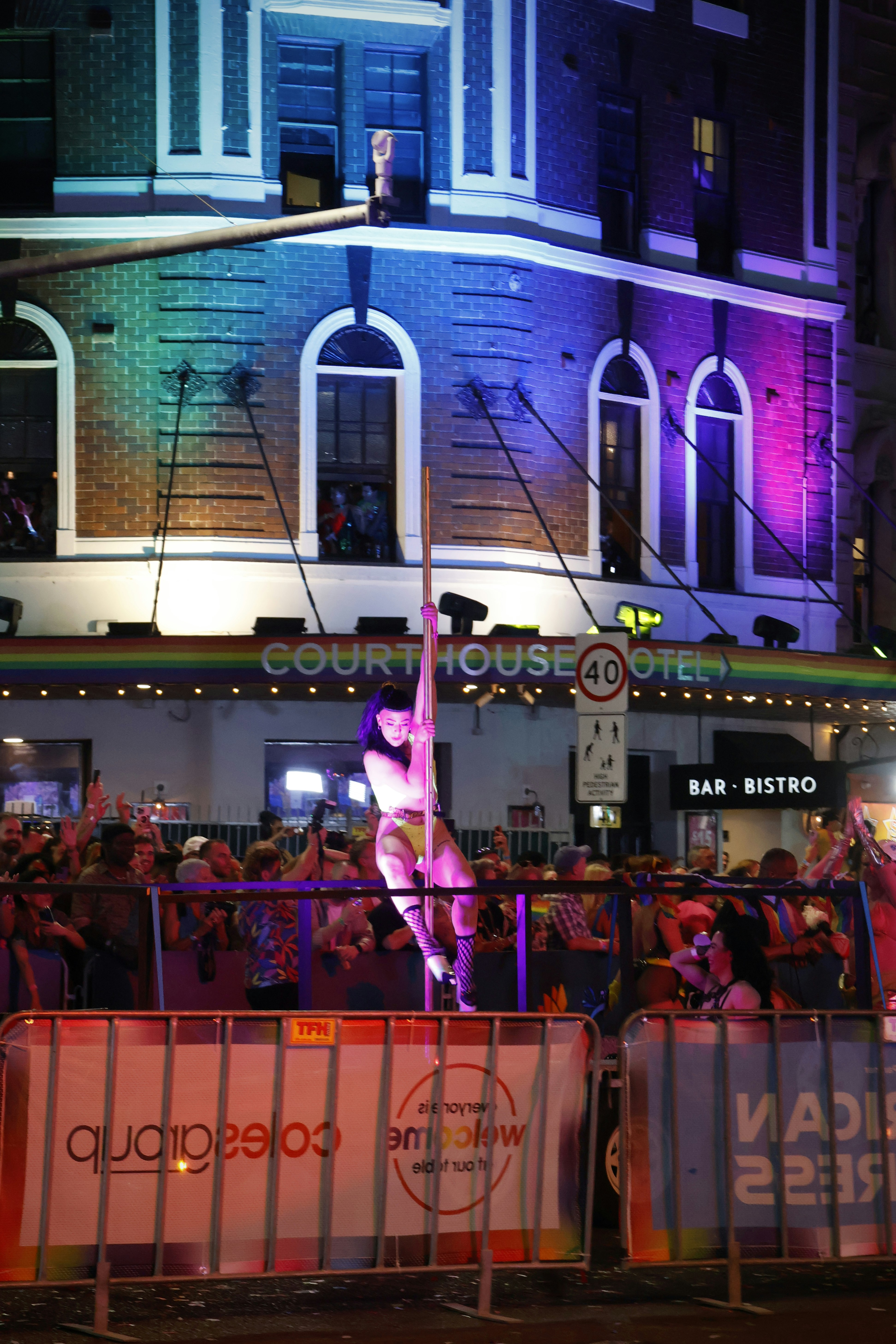 Woman performs on pole at night event