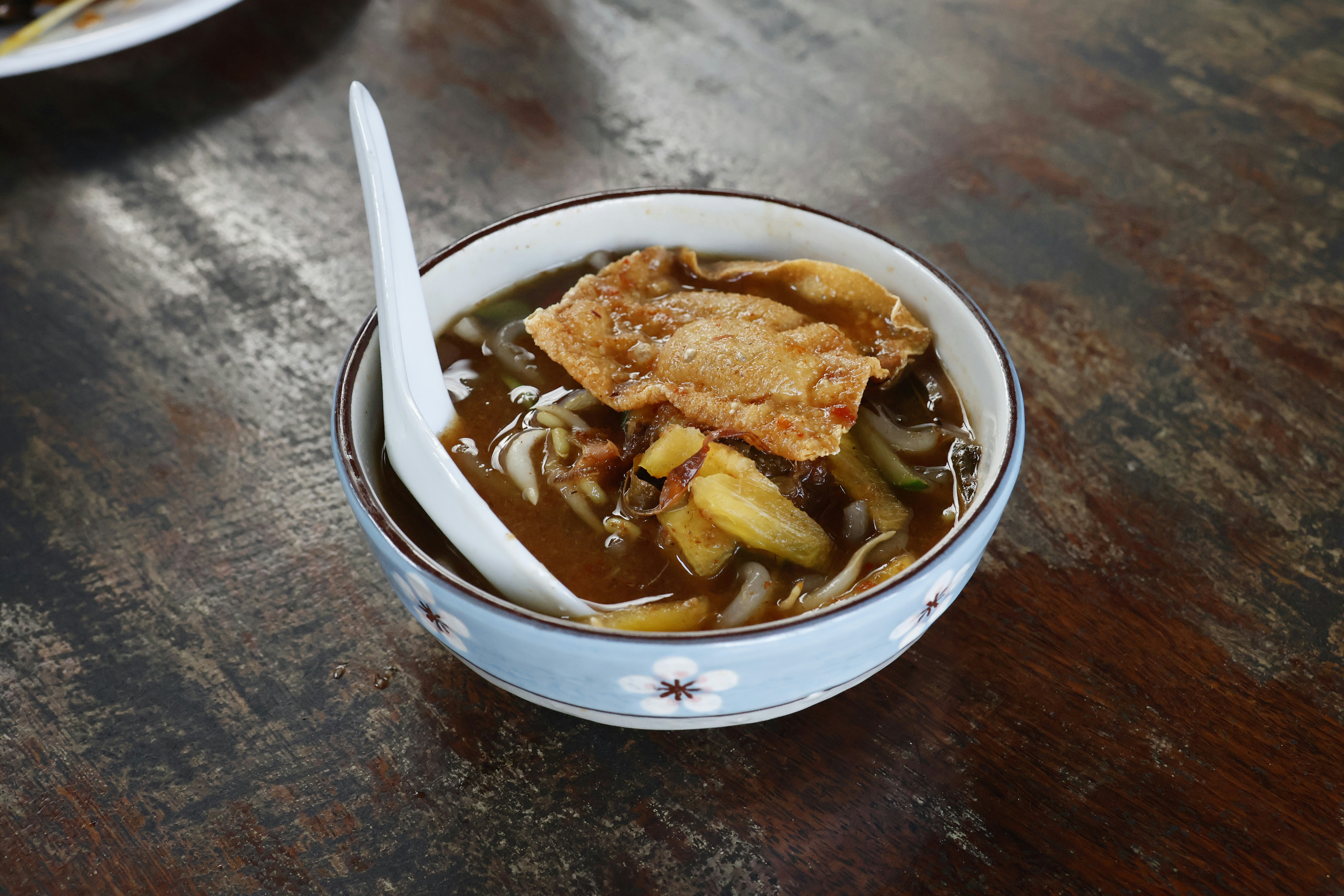 A bowl of hearty stew with meat and vegetables.