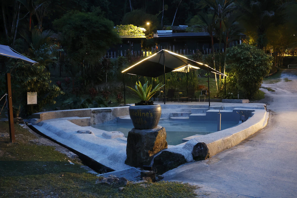 Volcanic hot springs illuminated at night in a Costa Rican jungle setting