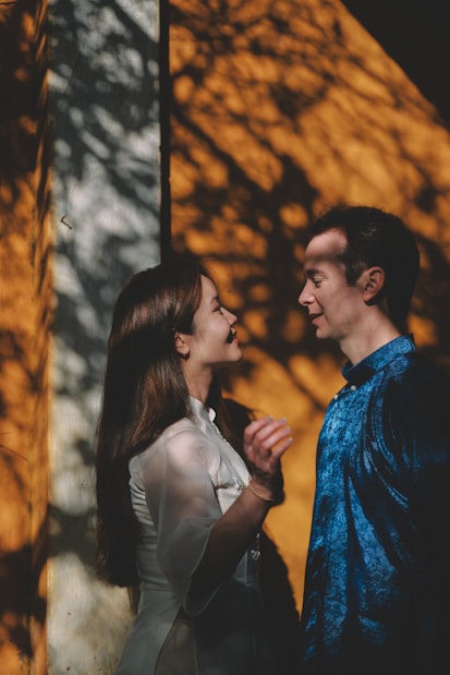 Couple looking at each other with dappled sunlight