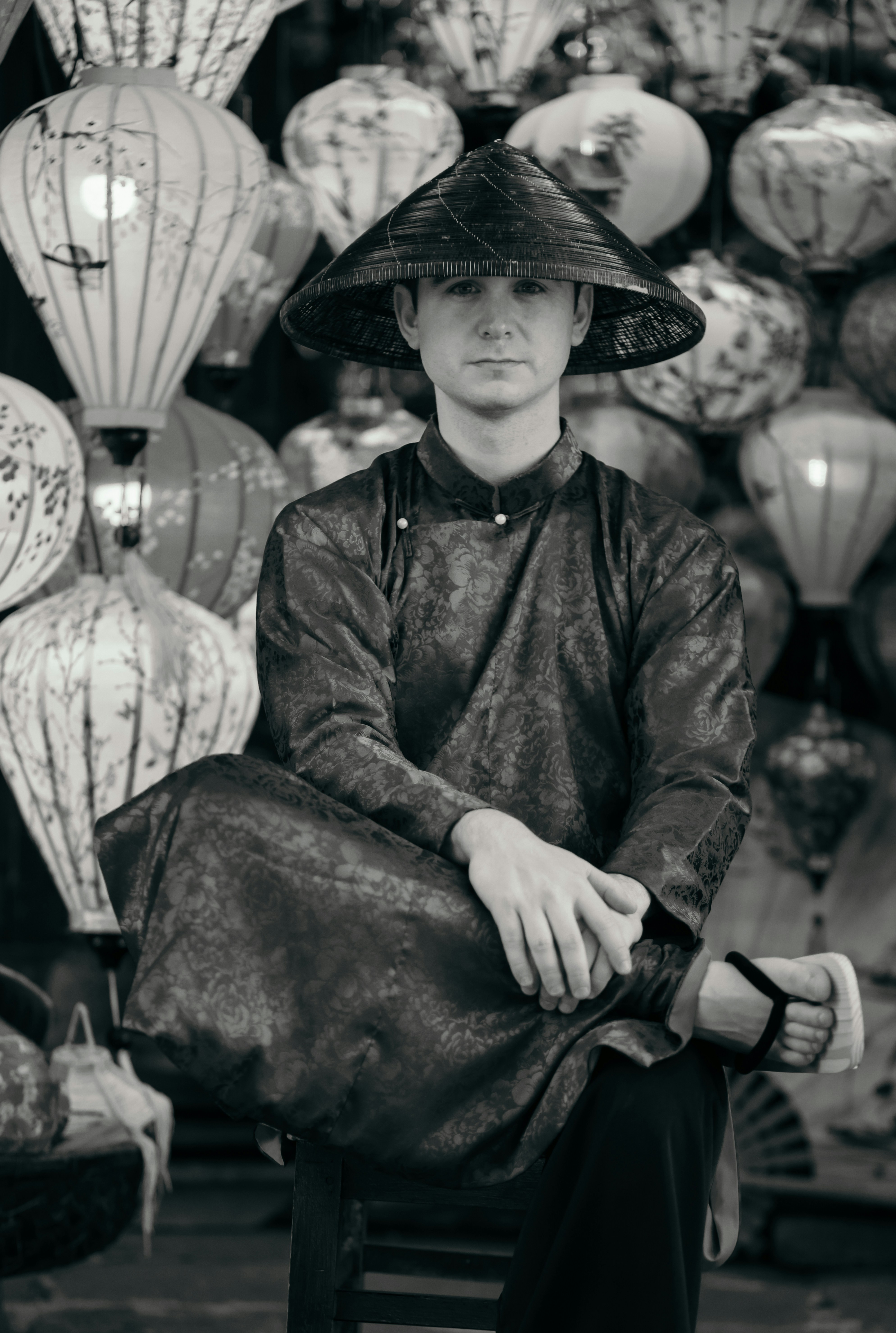 Man in traditional vietnamese clothing and conical hat.