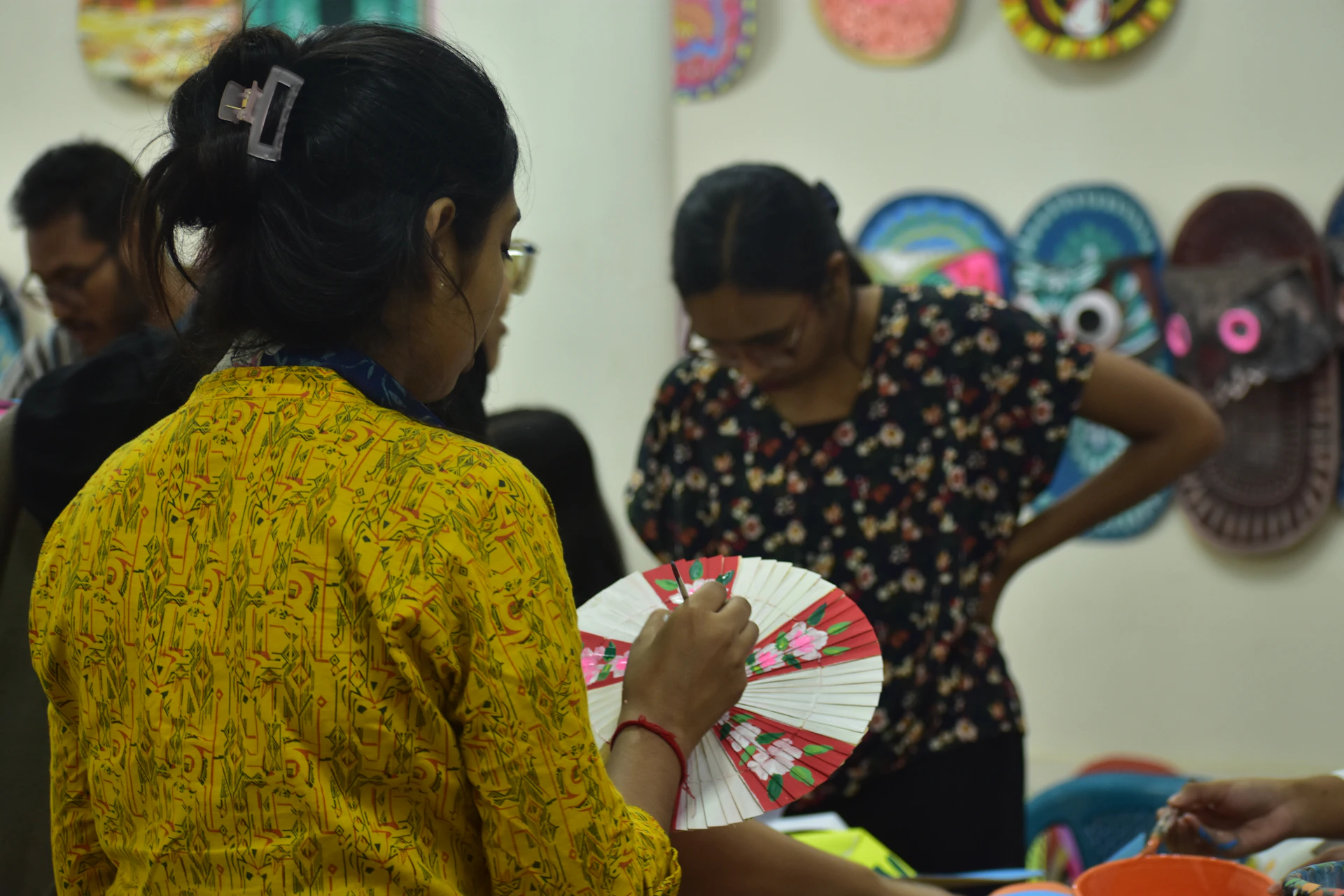 People crafting decorative paper art together