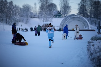 People enjoying winter activities in a snowy park