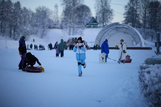 People enjoying winter activities in a snowy park
