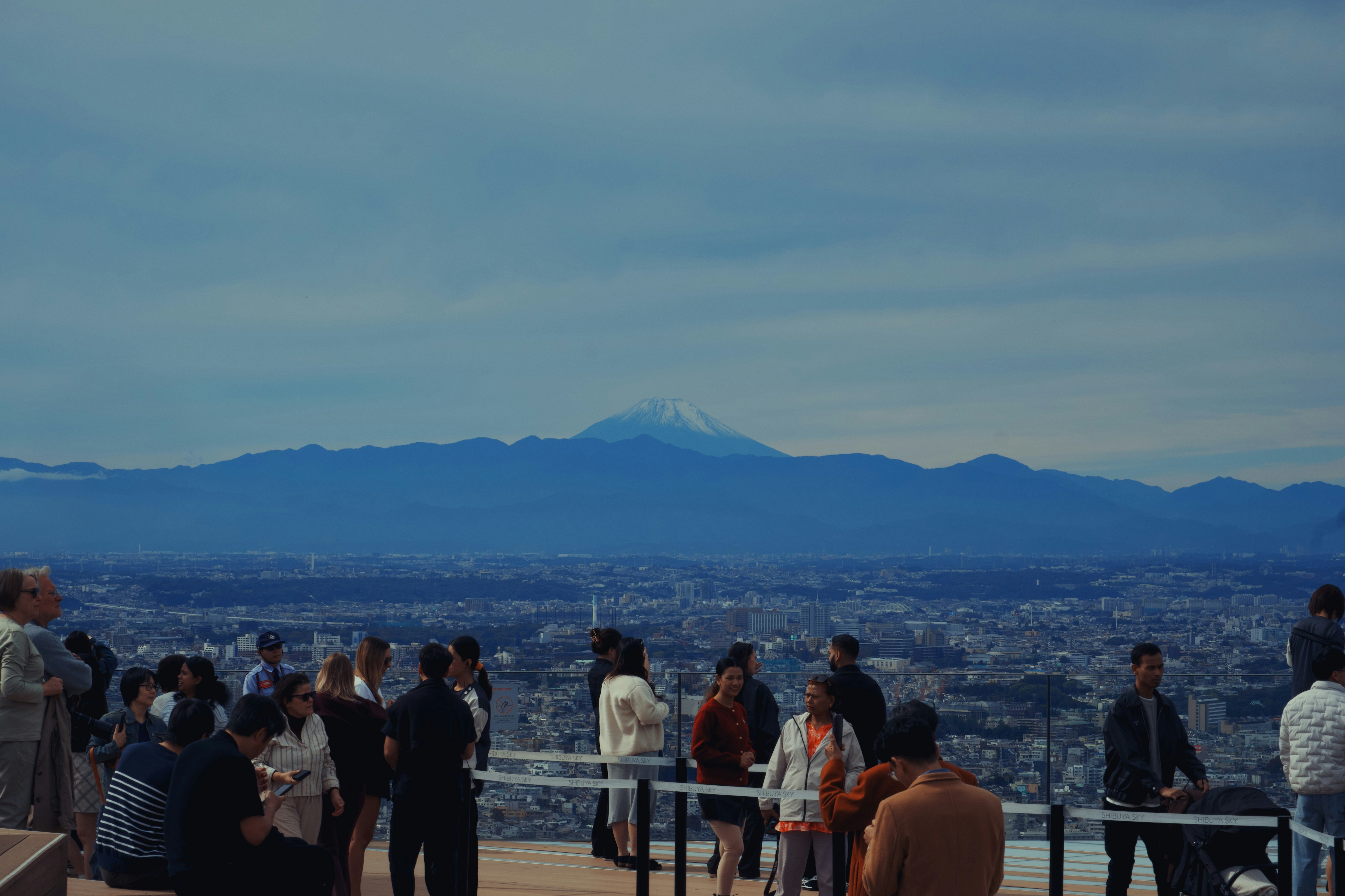 People observe mount fuji from an observation deck