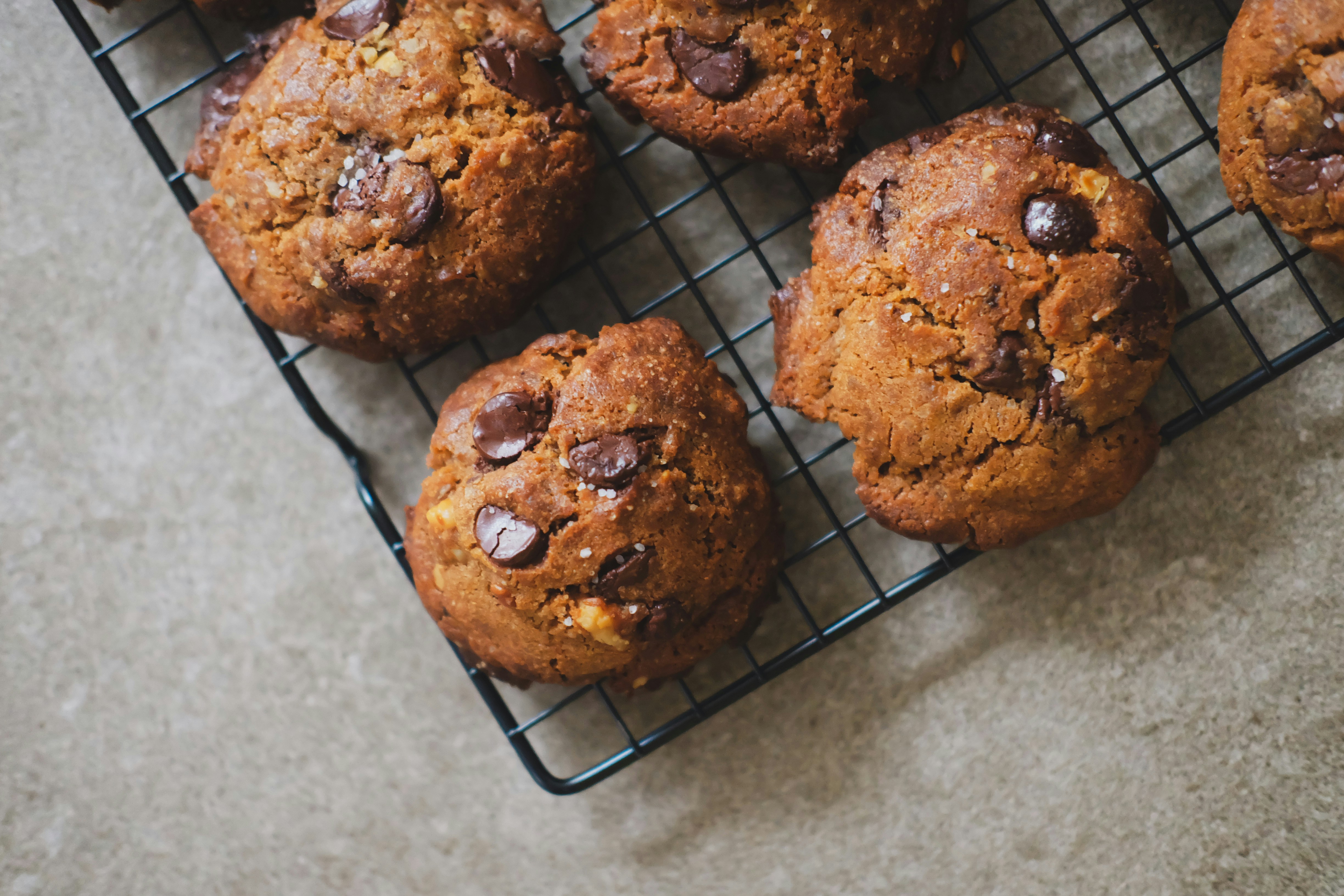 Chocolate chip cookies cooling on a wire rack.