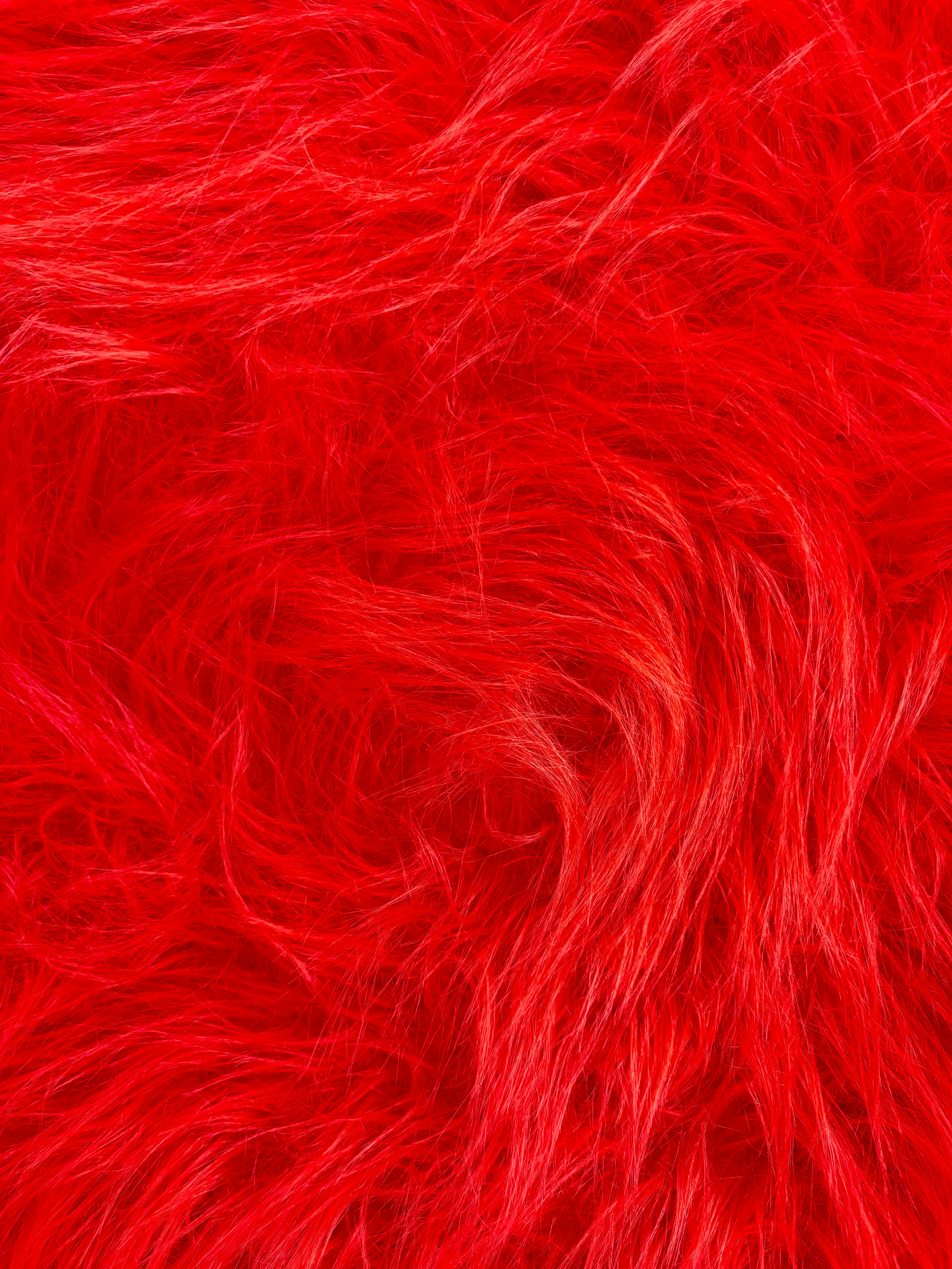 Close-up of vibrant red shaggy faux fur texture