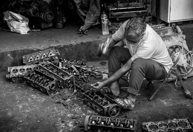 Mechanic working on car engine parts