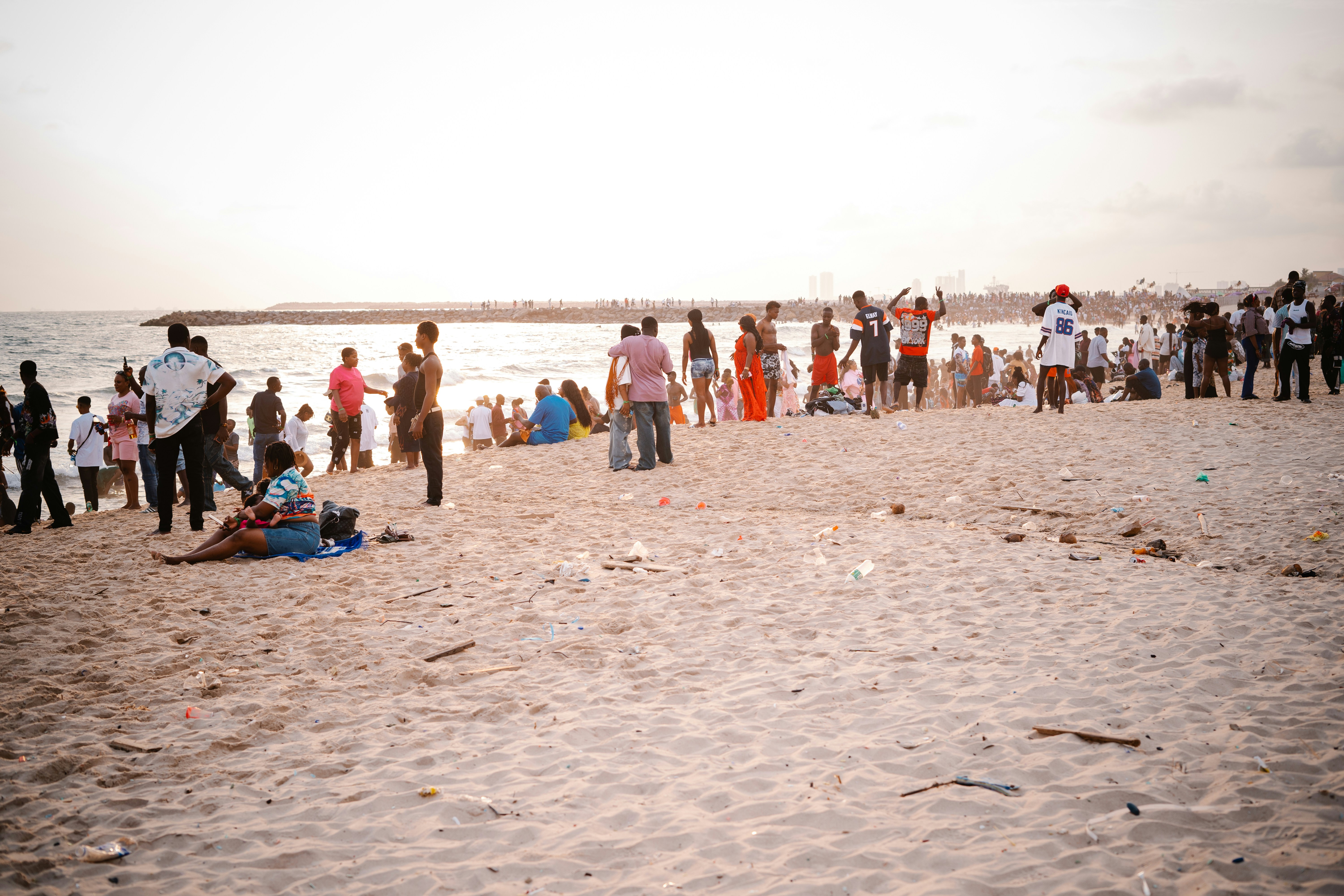 People gathered on a sandy beach near the ocean.