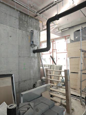 Industrial interior with pipes and construction materials.