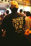 Man wearing a "jesus loves you" t-shirt