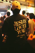 Man wearing a "jesus loves you" t-shirt
