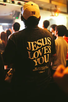 Man wearing a "jesus loves you" t-shirt