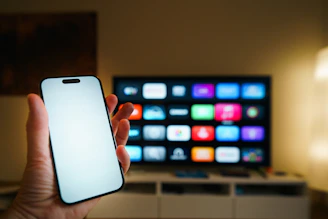 Smartphone held in front of a smart TV screen