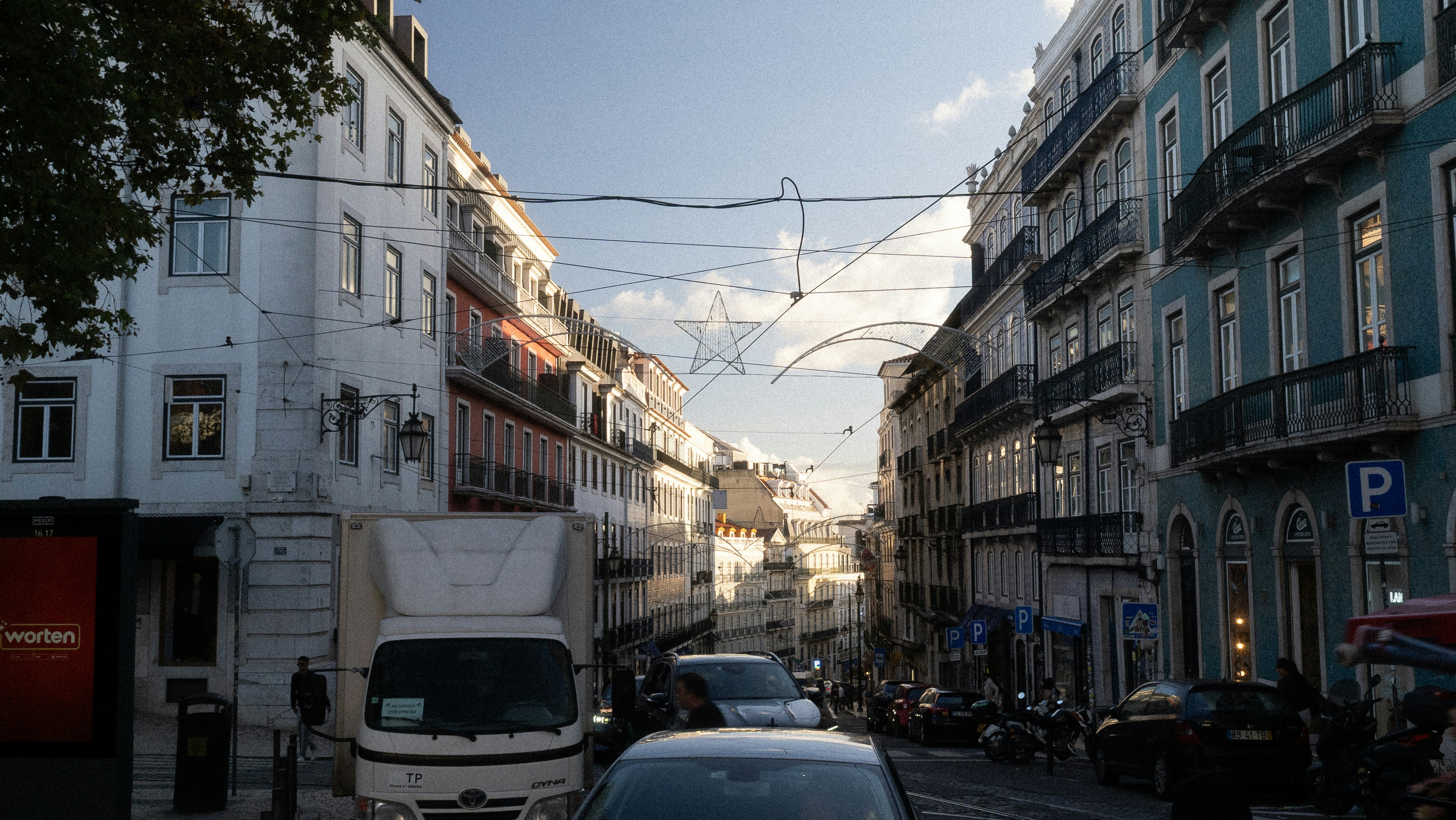 Street view of buildings and cars in a european city.