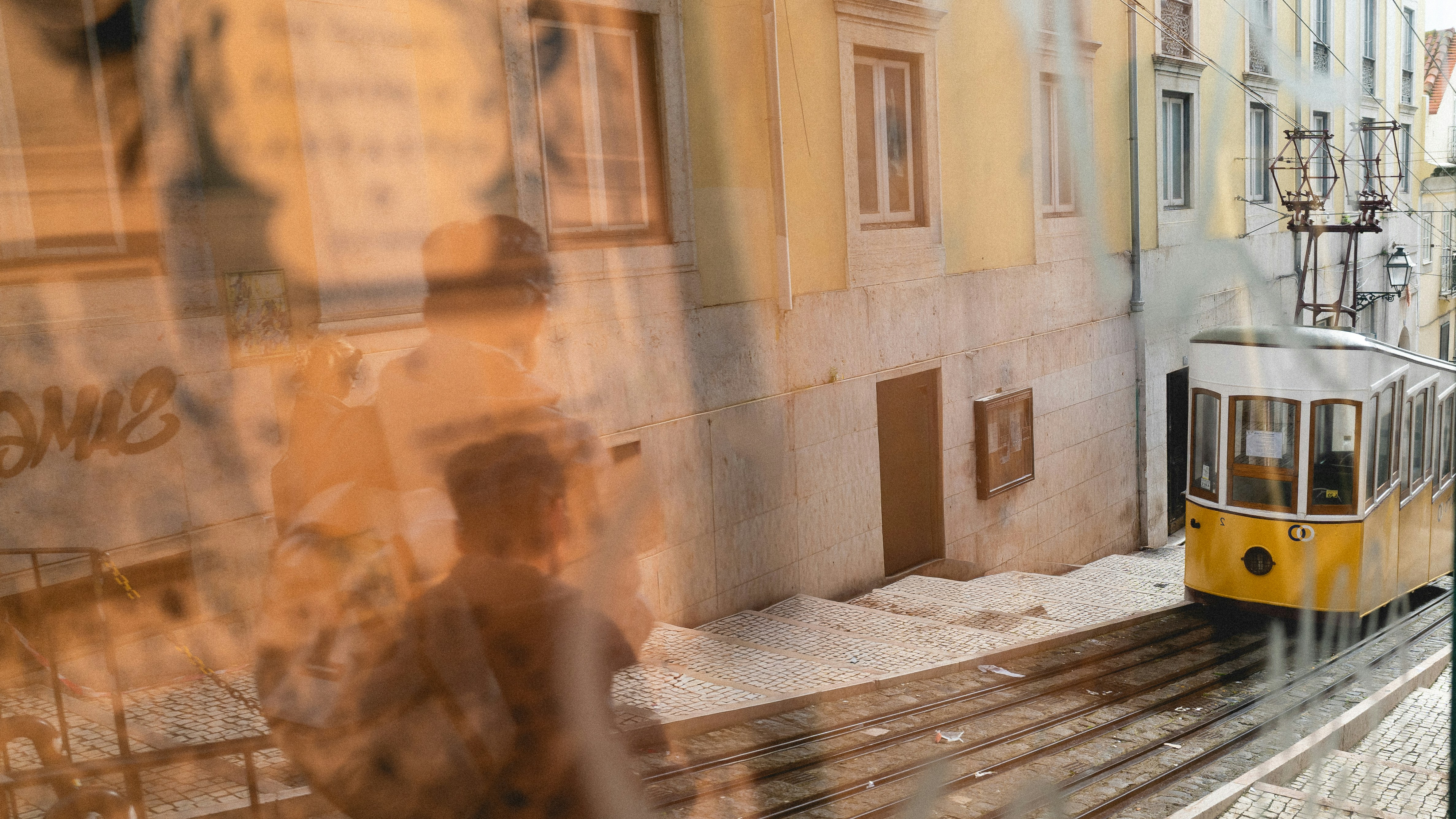Yellow tram on cobblestone street in lisbon