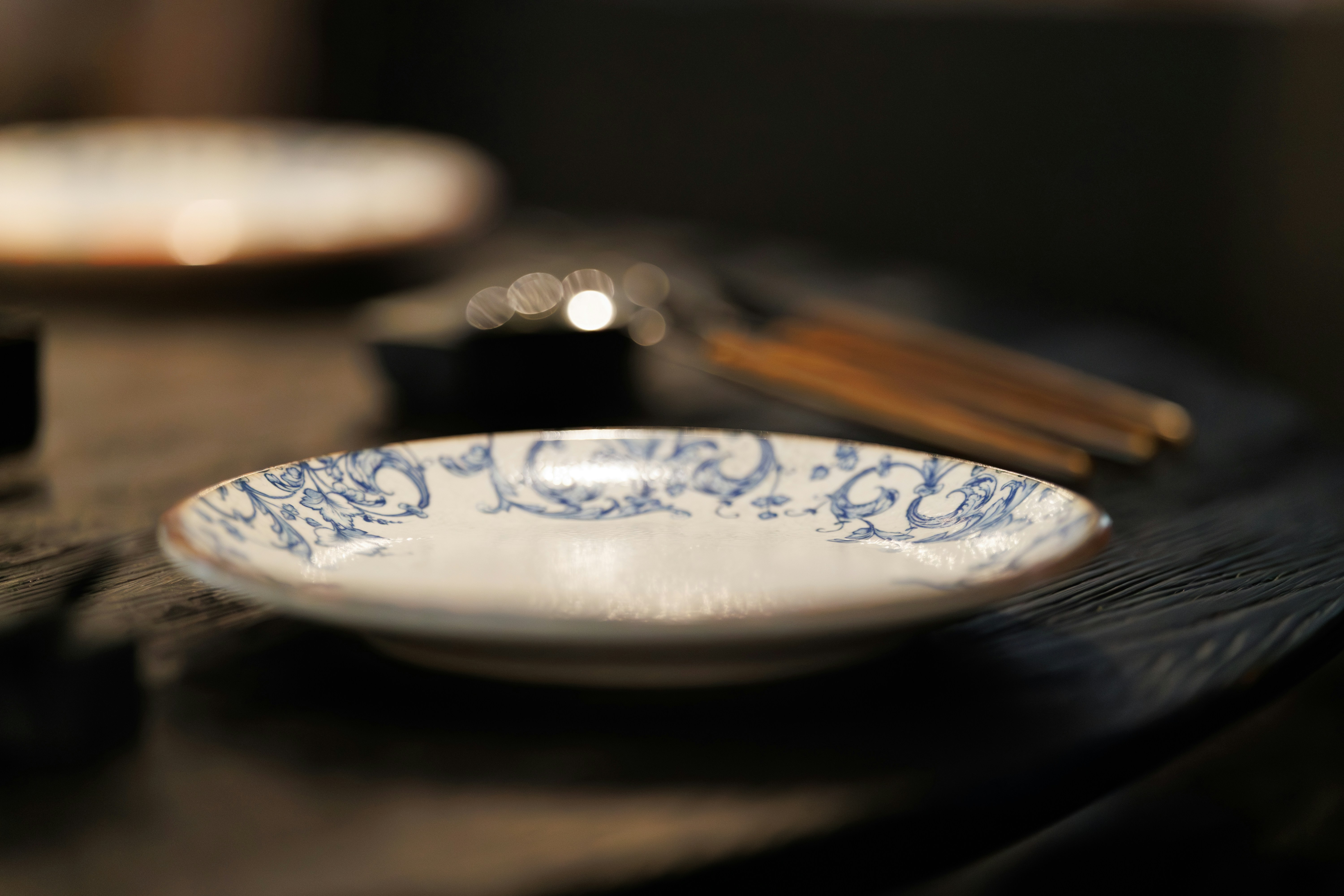 Small decorative plate with blue floral pattern.
