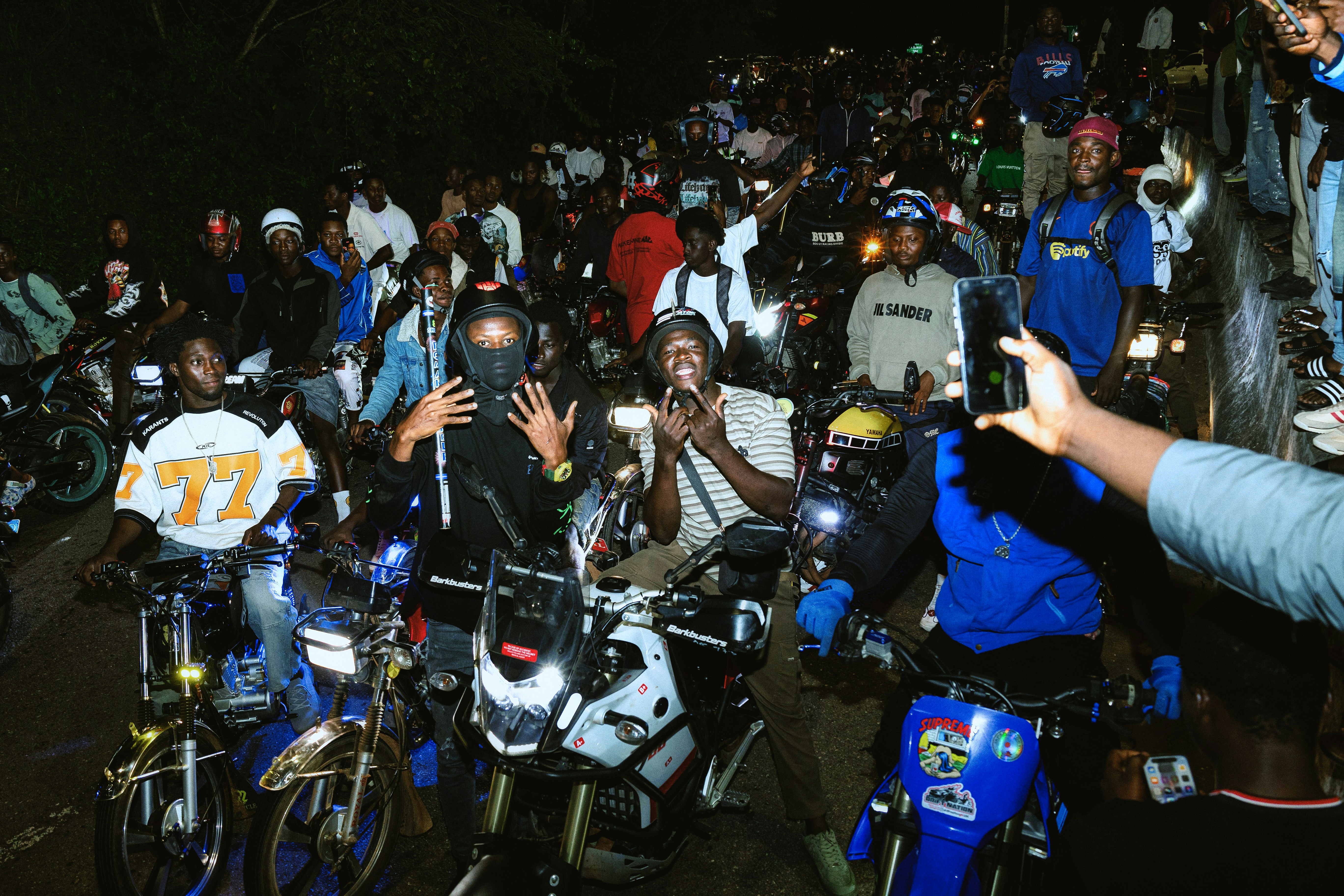Crowd of people on motorcycles at night