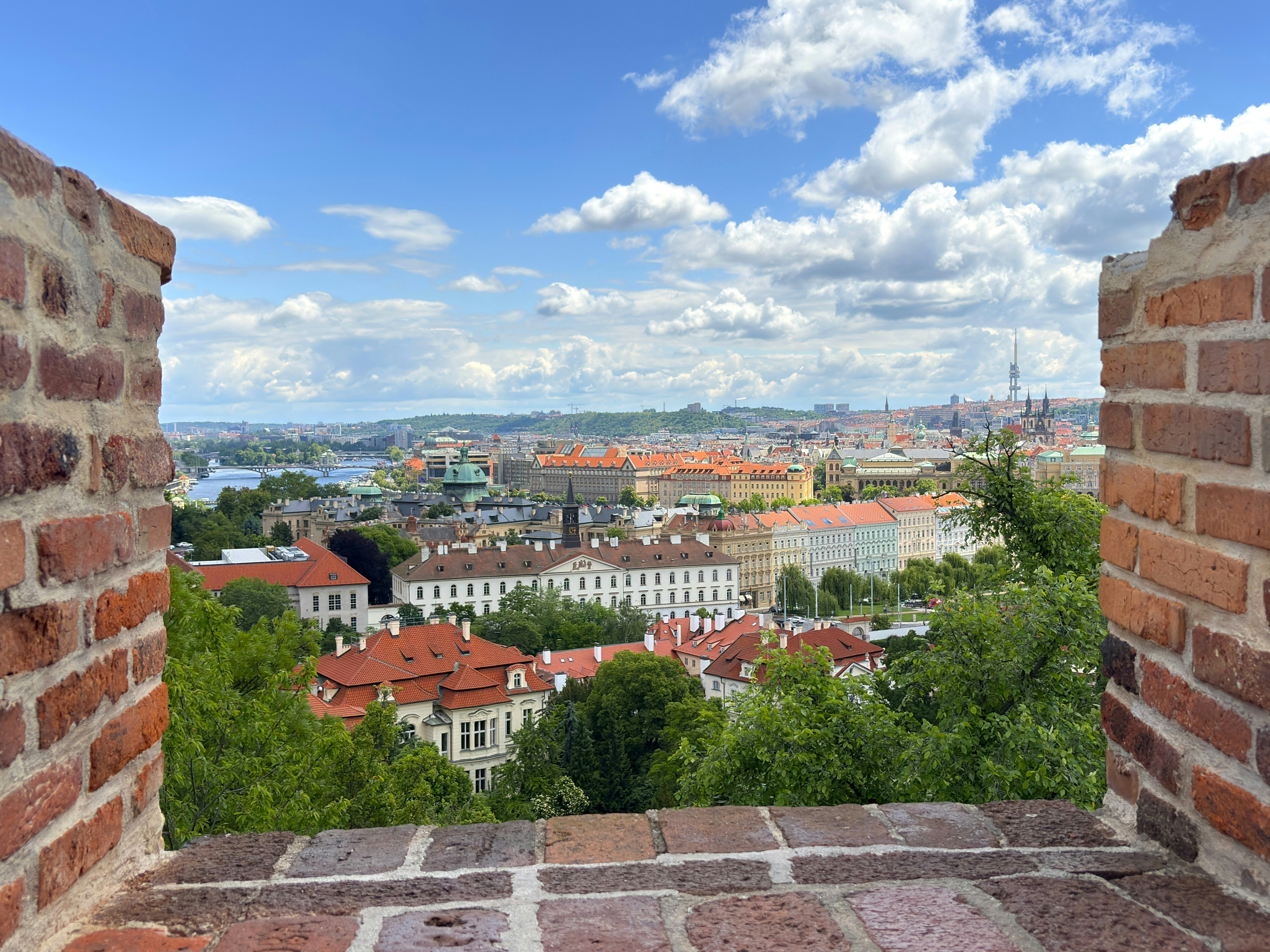 View of a city skyline with red tiled roofs.