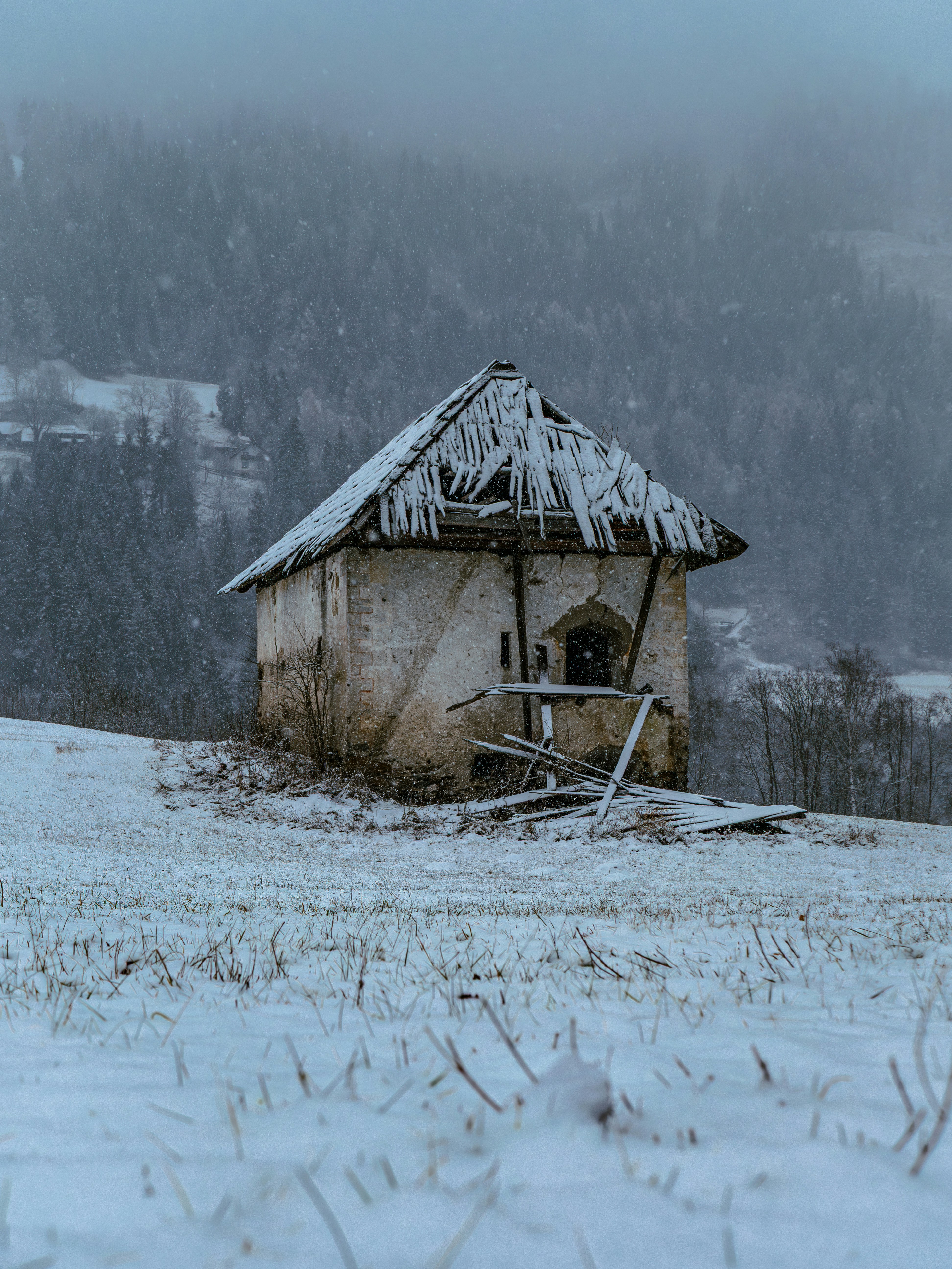 Old abandoned stone house in a snowy field