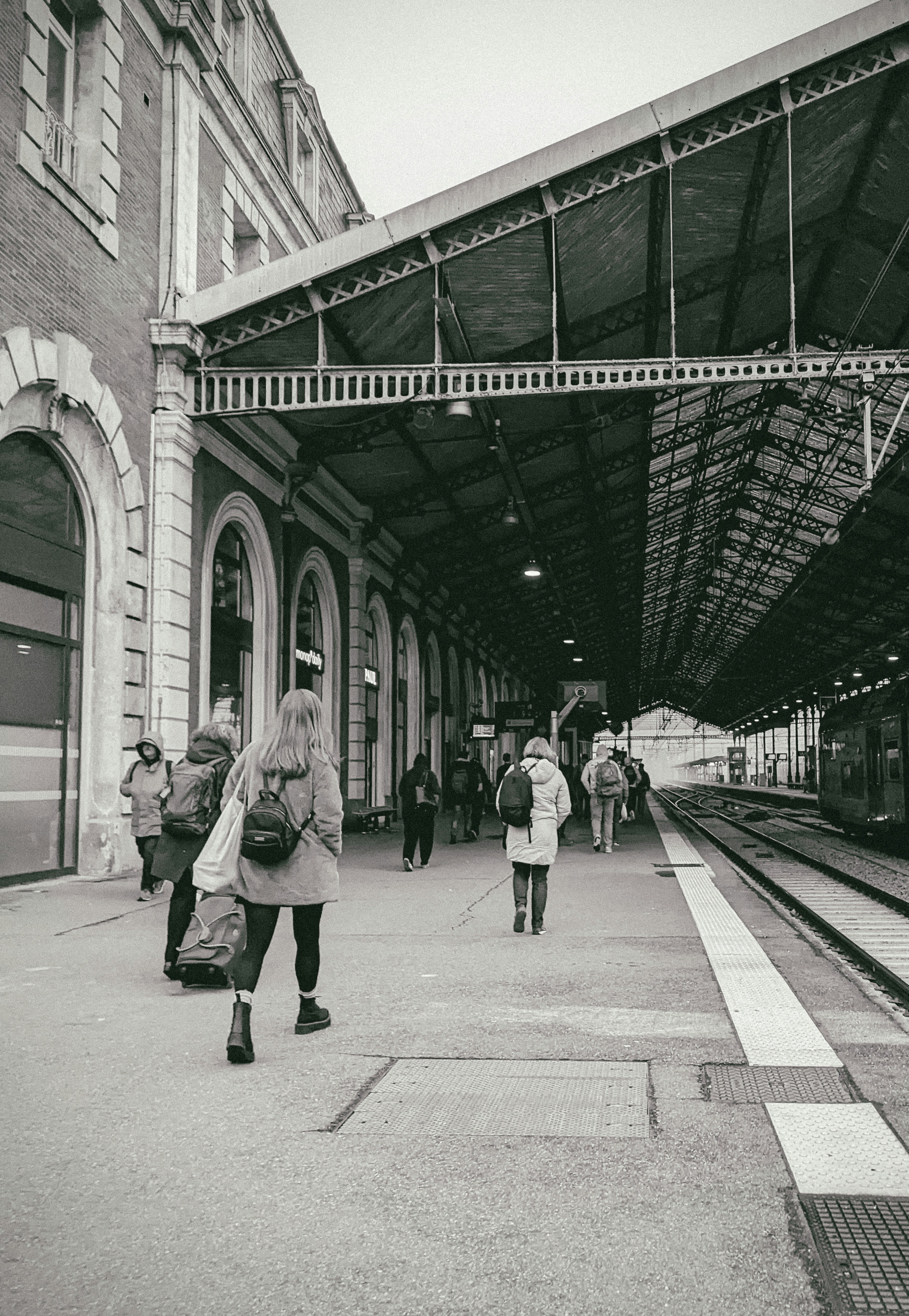 People walking on a train station platform