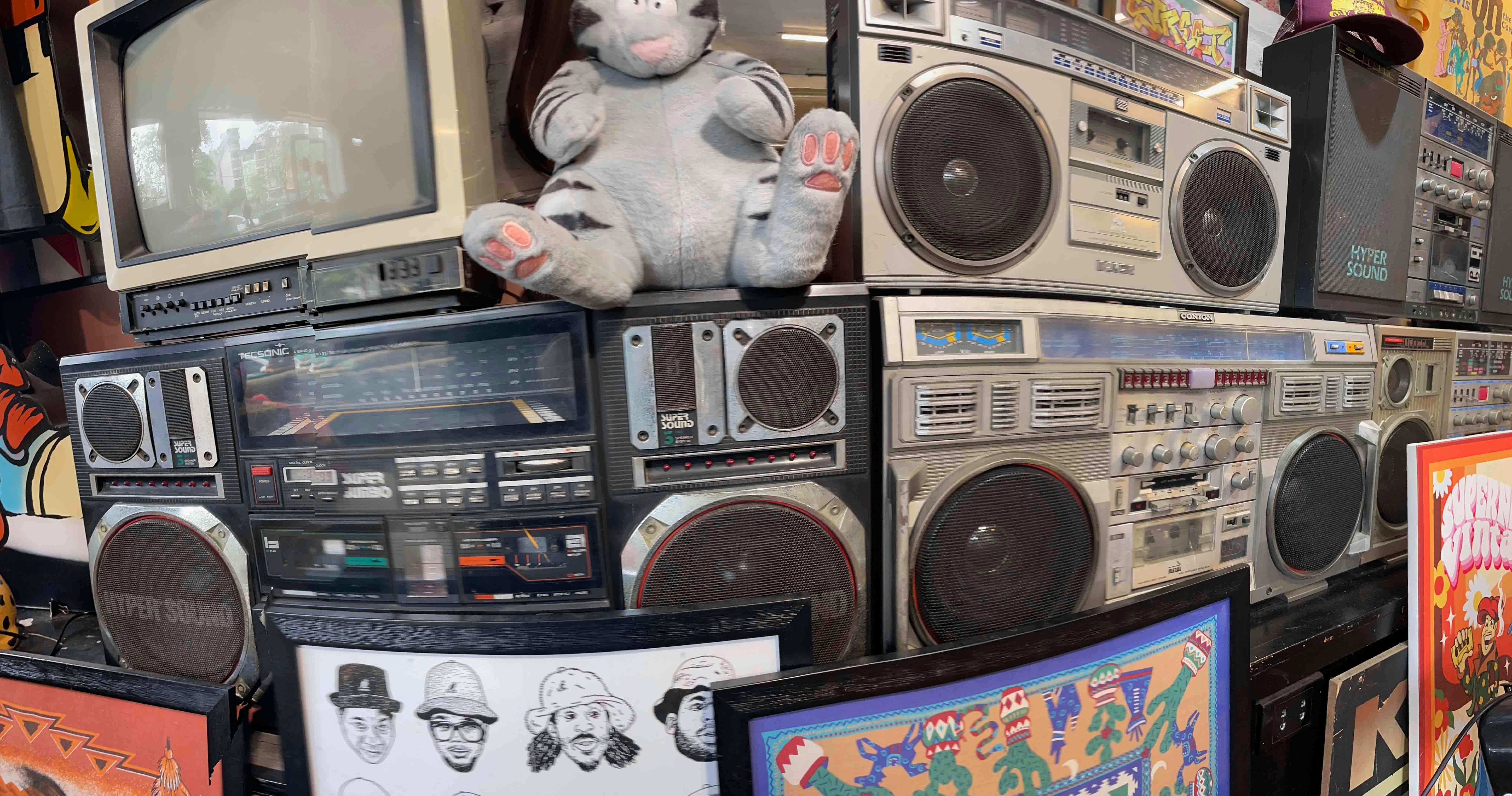 Stack of vintage boomboxes and old television.
